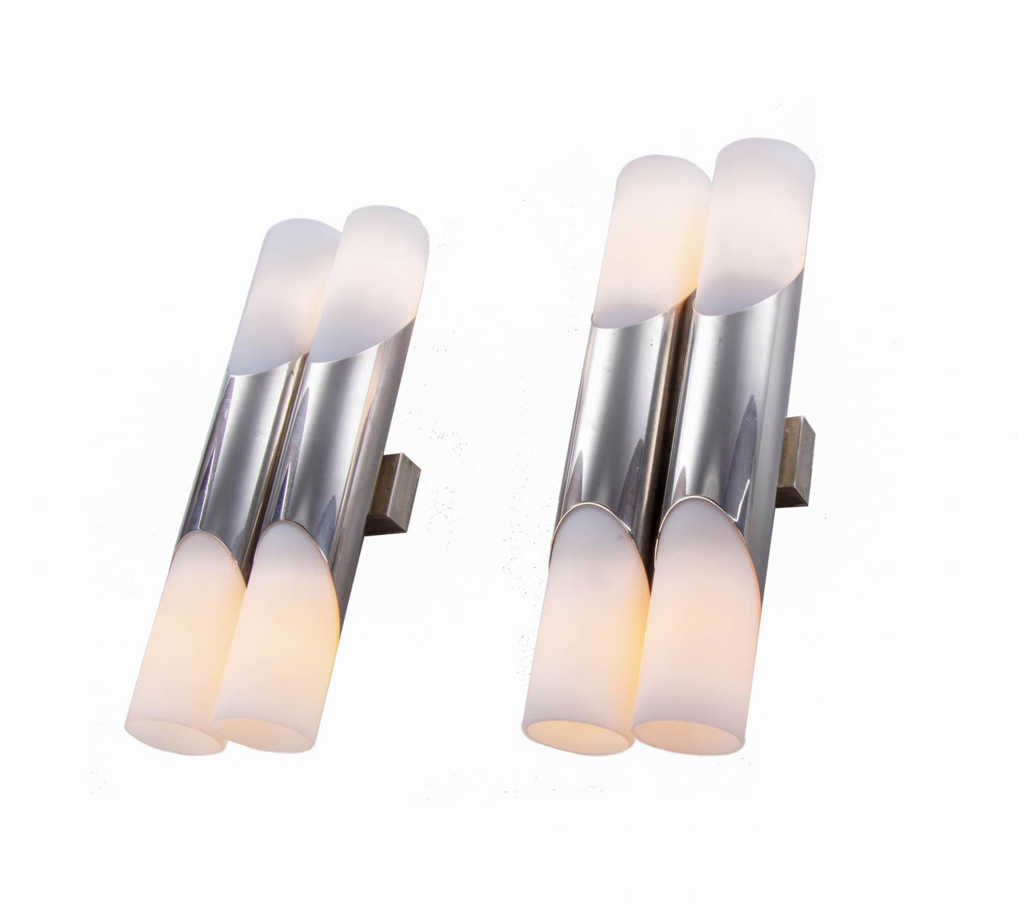 Elegant pair of modernist double wall sconces with white opal glass diffusers on a tubular chromed frame. Designed by Rolf Kruger. Manufactured by Neuhaus Lighting, Germany in the 1970s. 

Design: Rolf Kruger. 
Style: mid century, modernist.