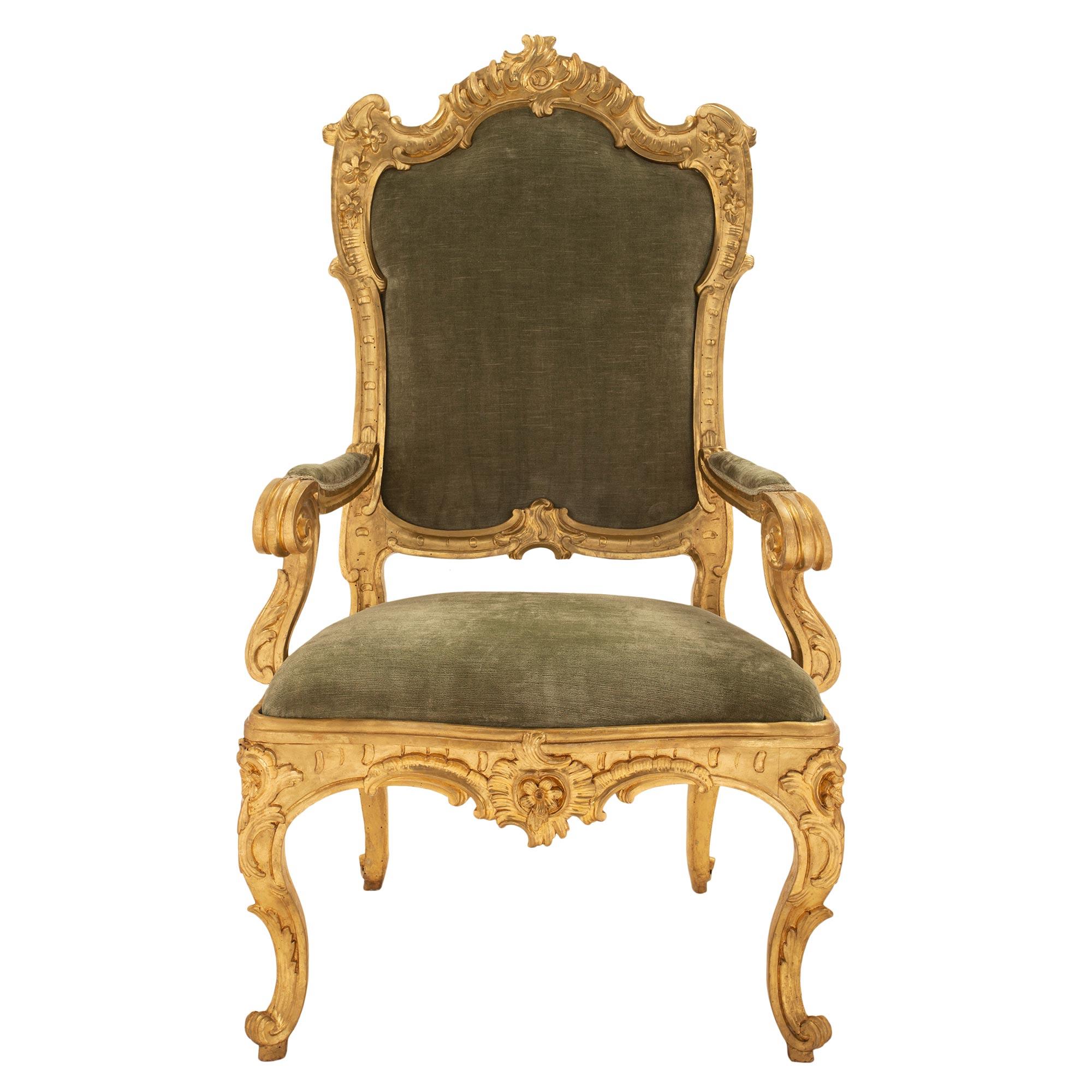 A spectacular and high quality pair of large scaled Roman 18th century Louis XV period giltwood throne armchairs. This pair of chairs are 'A Chasis' which signifies the ease of removing the seat and back enabling to change the upholstery for each