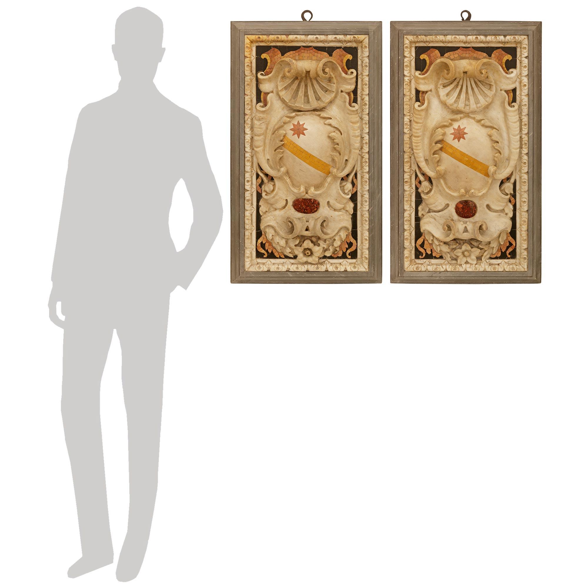An important and most impressive pair of Roman late 17th/early 18th century Baroque Period Marble crest/plaques. Each stunning rectangular shaped marble plaque is designed in the style of an Italian noble family crest, and set within a mottled Gris