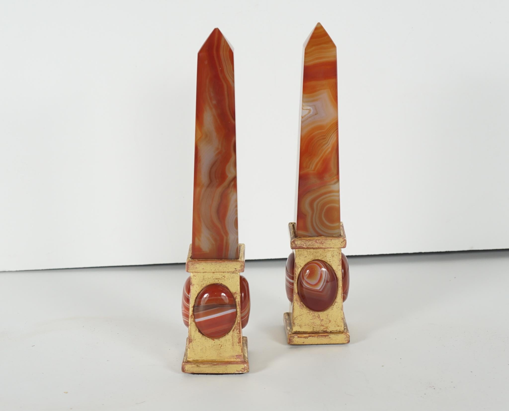 This very decorative pair of sardonyx obelisks are custom made and come from Rome The pair was made circa 1990 as part of a tabletop decorative scheme that included other hard stone obelisks and vases. The hardstone is set into carved and water