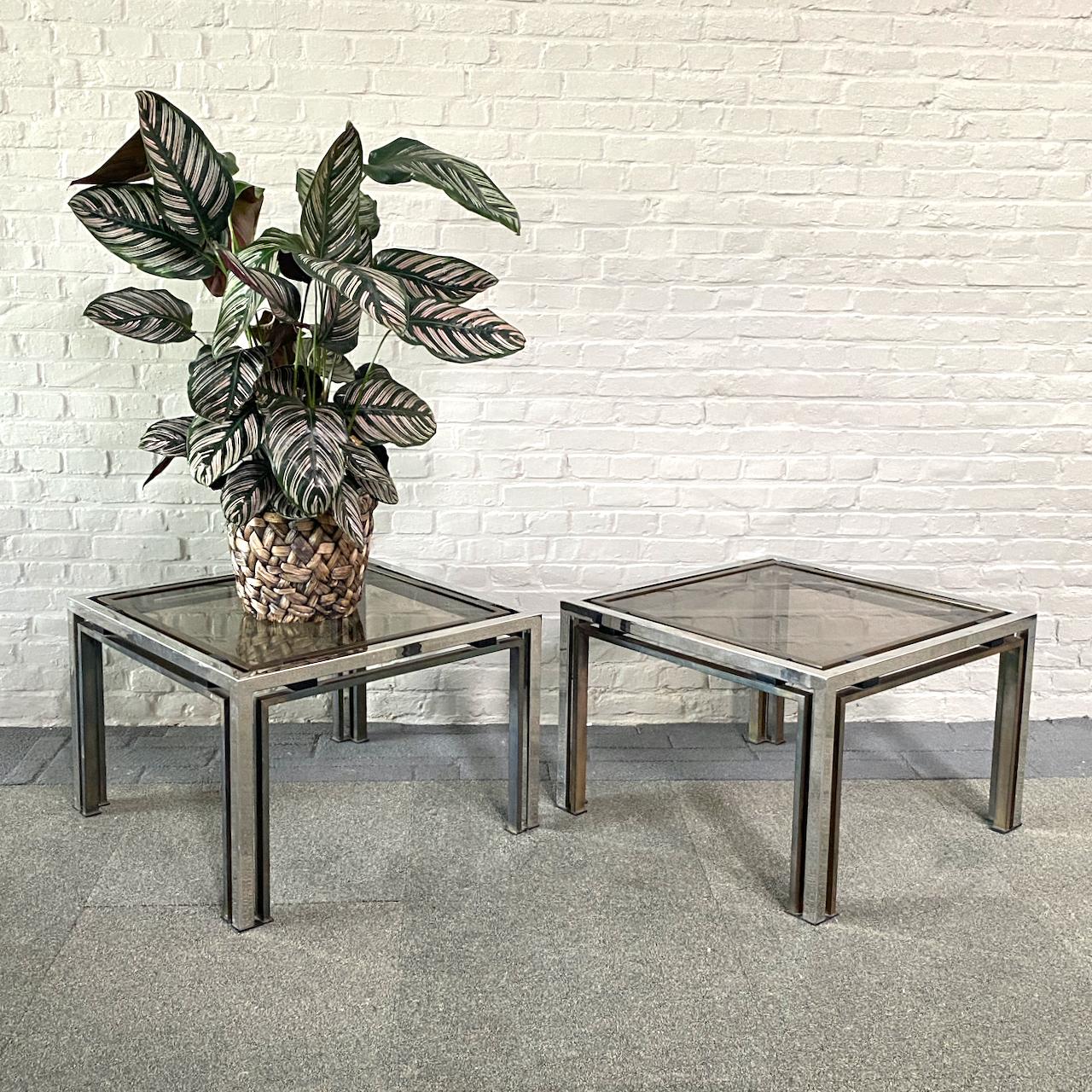 Pair of Romeo Rega chrome & brass side tables

Attributed to Romeo Rega:
He combined modernism with Hollywood Regency glamour.

Untouched brass patina
Chromed
Black acrylic accents
Smoked glass tops
1970's
Italian production

Condition:
The pair of