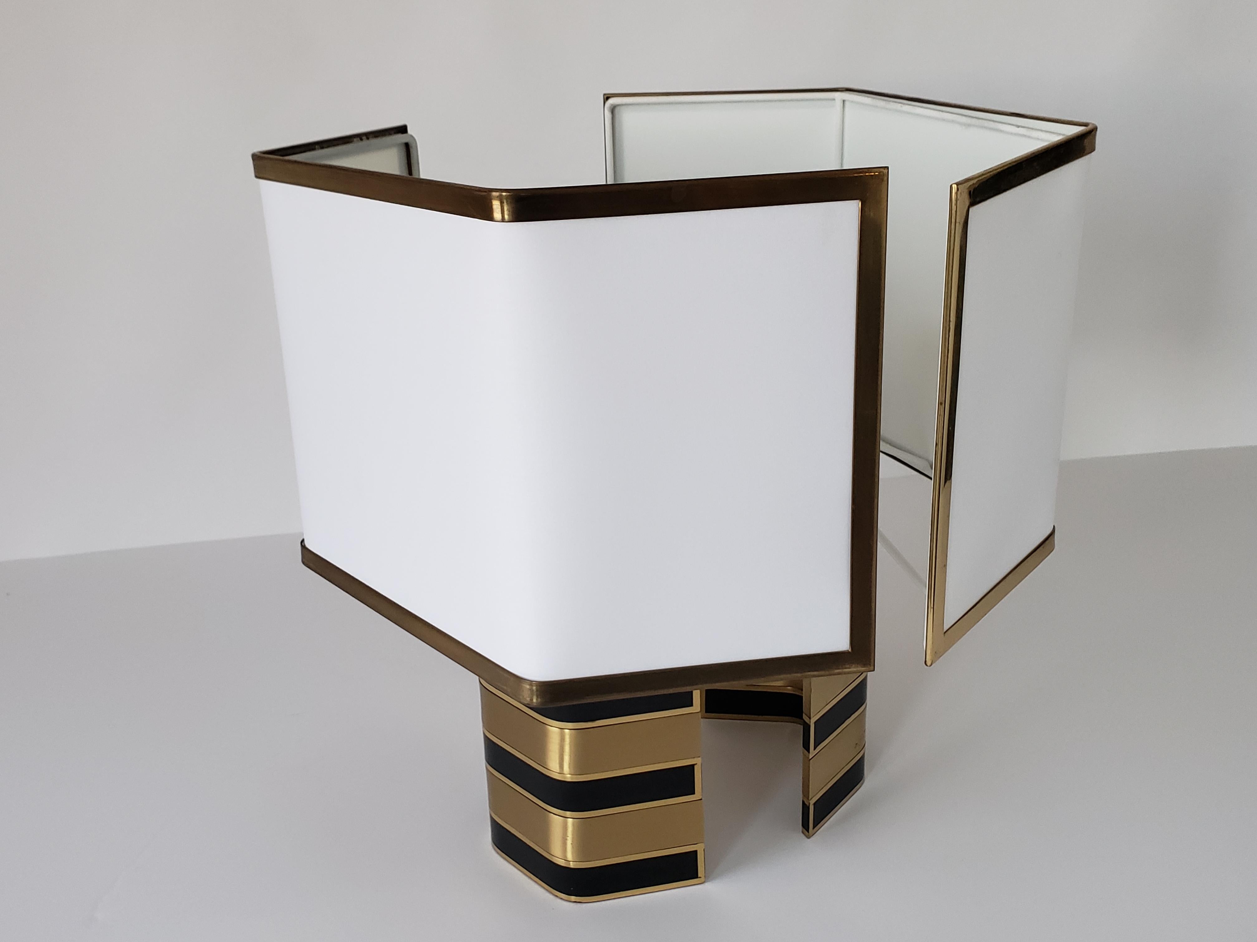 Rare open back designed table lamp for near wall installation from Romeo Rega.

The base is made of thick solid lacquered brass with enameled black brass horizontal insert. 

One regular E26 size socket rated at 100 watts maximum. 

Switch on