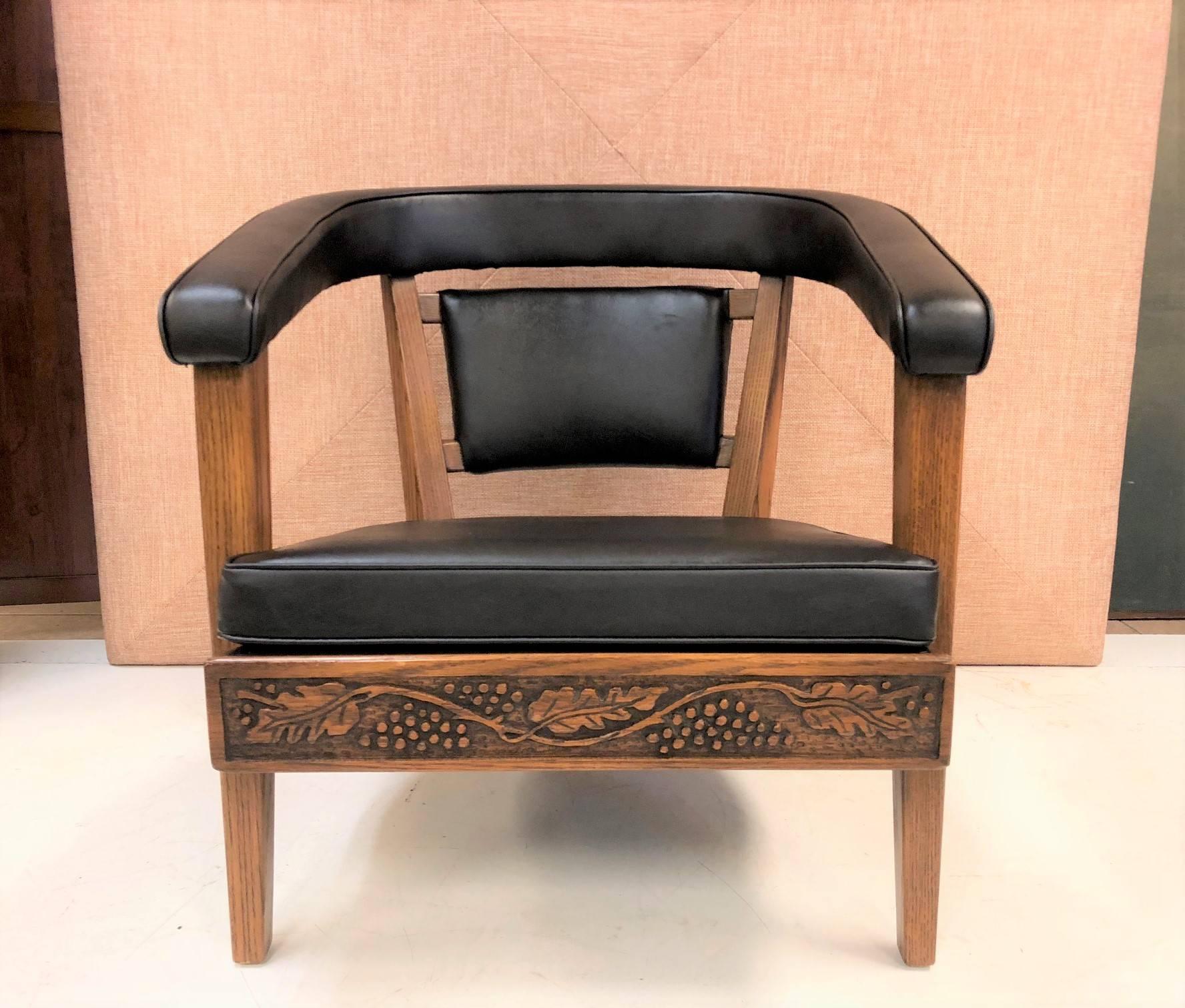 Pair of Romweber carved oak lounge chairs newly upholstered in black vinyl. Frames are heavily carved.