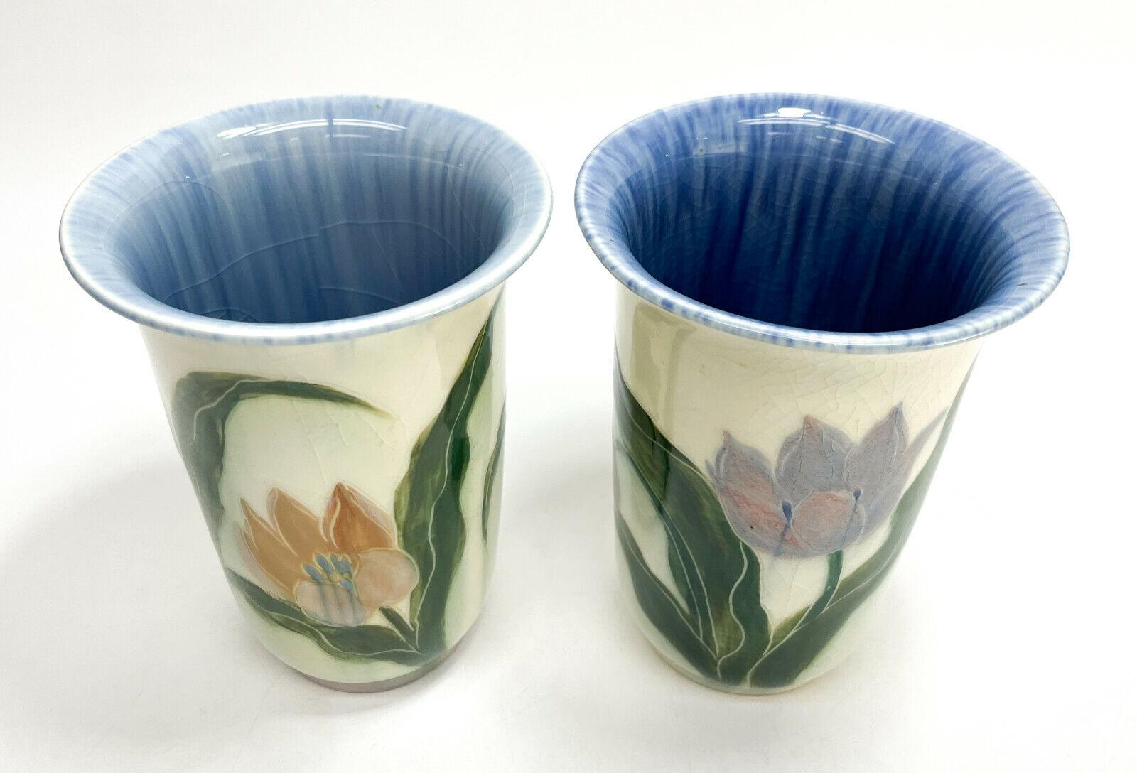 Pair of rookwood pottery vases by E.T. Hurley #6806, hand painted tulips, 1943.

Hand painted orange and purple tulips throughout the exterior with a blue interior. Rookwood mark to the underside base.

Additional information:
Features: Hand