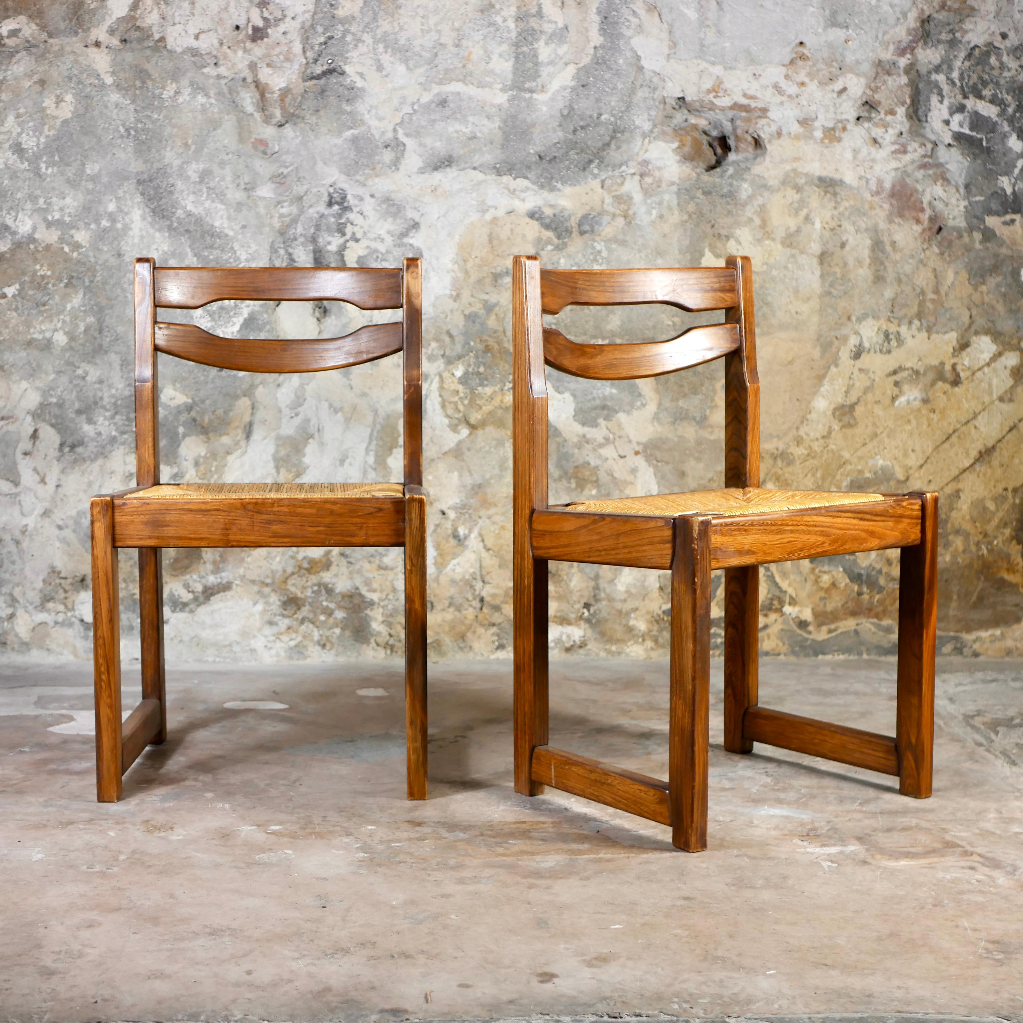 Nice pair of 2 chairs in the style of Maison Regain, made in France in the 1970s.
Rope seat, elm structure. 
We love the wood grain and tint.
Overall good condition, rope used, some traces of repair on the wood.
Dimensions : H80, W50, D43