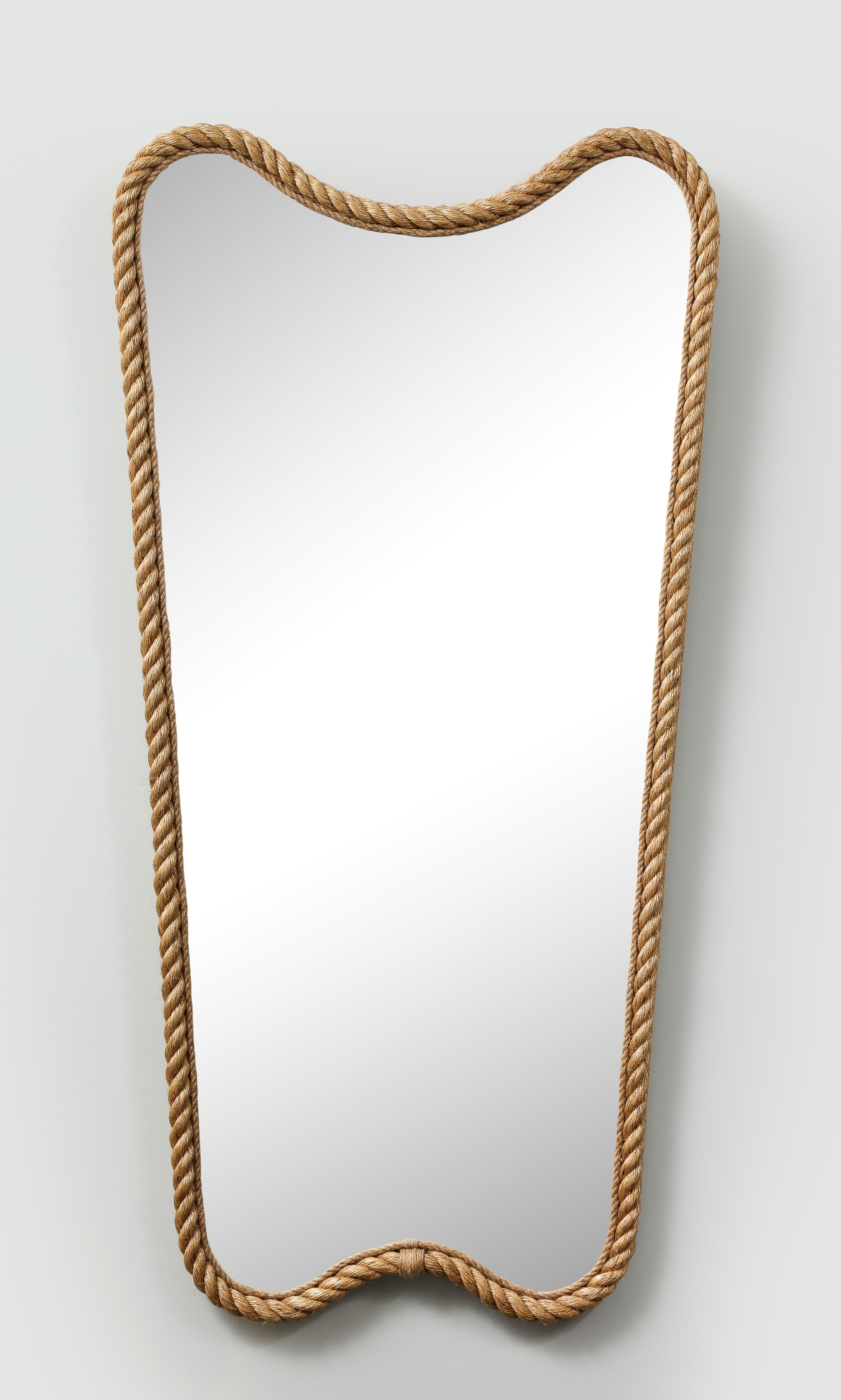 Elegant pair of mirrors made with rope in the manner of Audoux. These mirrors were made by a French artisan. Their scale and their shape make them outstanding on a wall.