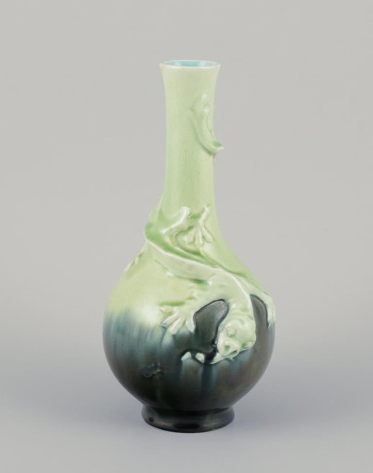 A pair of Rörstrand Art Nouveau faience vases.
Hand-decorated glaze in green tones.
Relief motif of lizards.
Approximately 1900.
In perfect condition.
Dimensions: H 24.0 cm x D 10.5 cm / H 23.5 cm x D 10.5 cm.