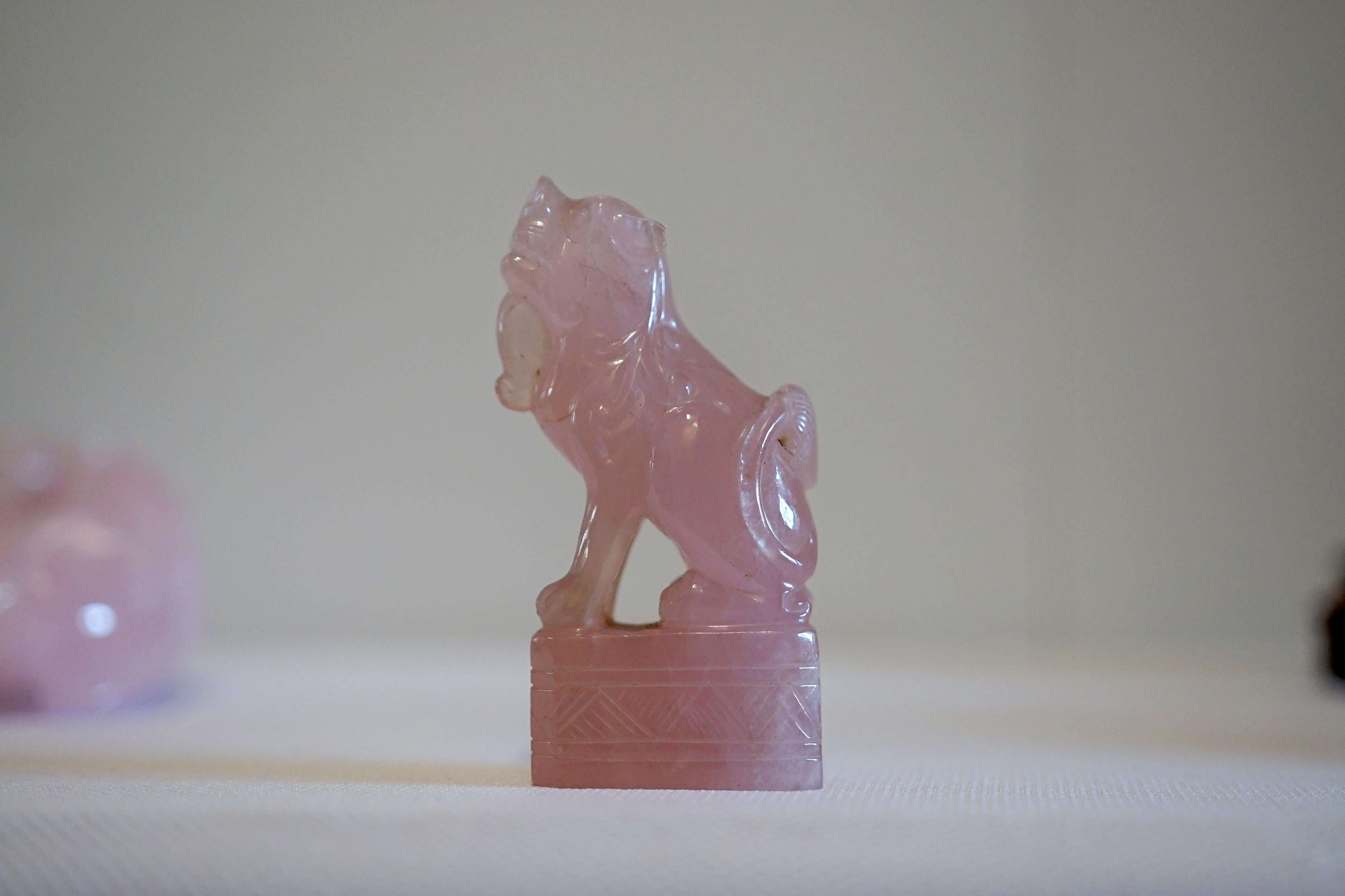 These noble beasts are often placed near the entrance of a home for fierce protection. The pair of hand-carved rose quartz foo dogs (also known as guardian lions) exudes protective strength and artistry. They are fierce, but they are charming and