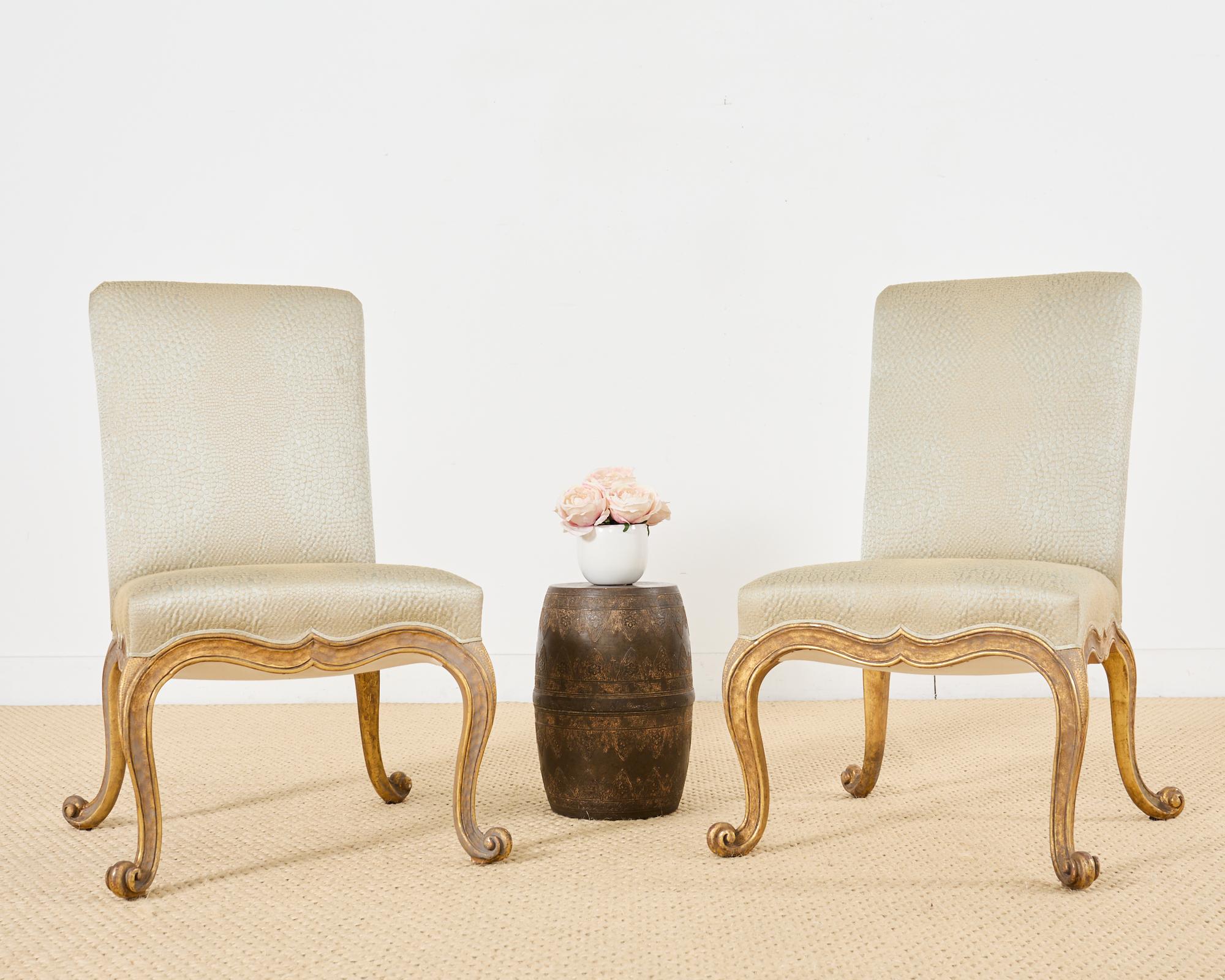 Sublime pair of Baroque style Kent dining chairs by Rose Tarlow Melrose House Hollywood, CA. The bespoke chairs feature a 22k gold leaf finish with an intentionally aged patina. The large beech wood frames have a square back and generous seat with a