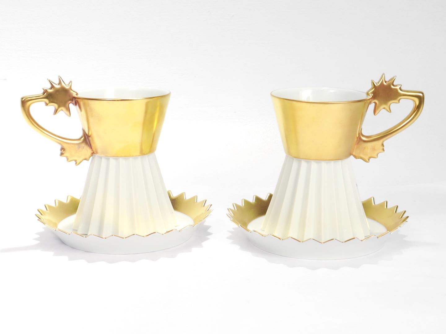 A pair of fine porcelain cups & saucers.

By Rosenthal.

In the Künstlertasse Nr. 23 (lit. Artist Cup) pattern designed by Otto Piene.

Both cup and saucer are richly gilded and have a multi-faceted, star shaped design.

Each marked to the base with