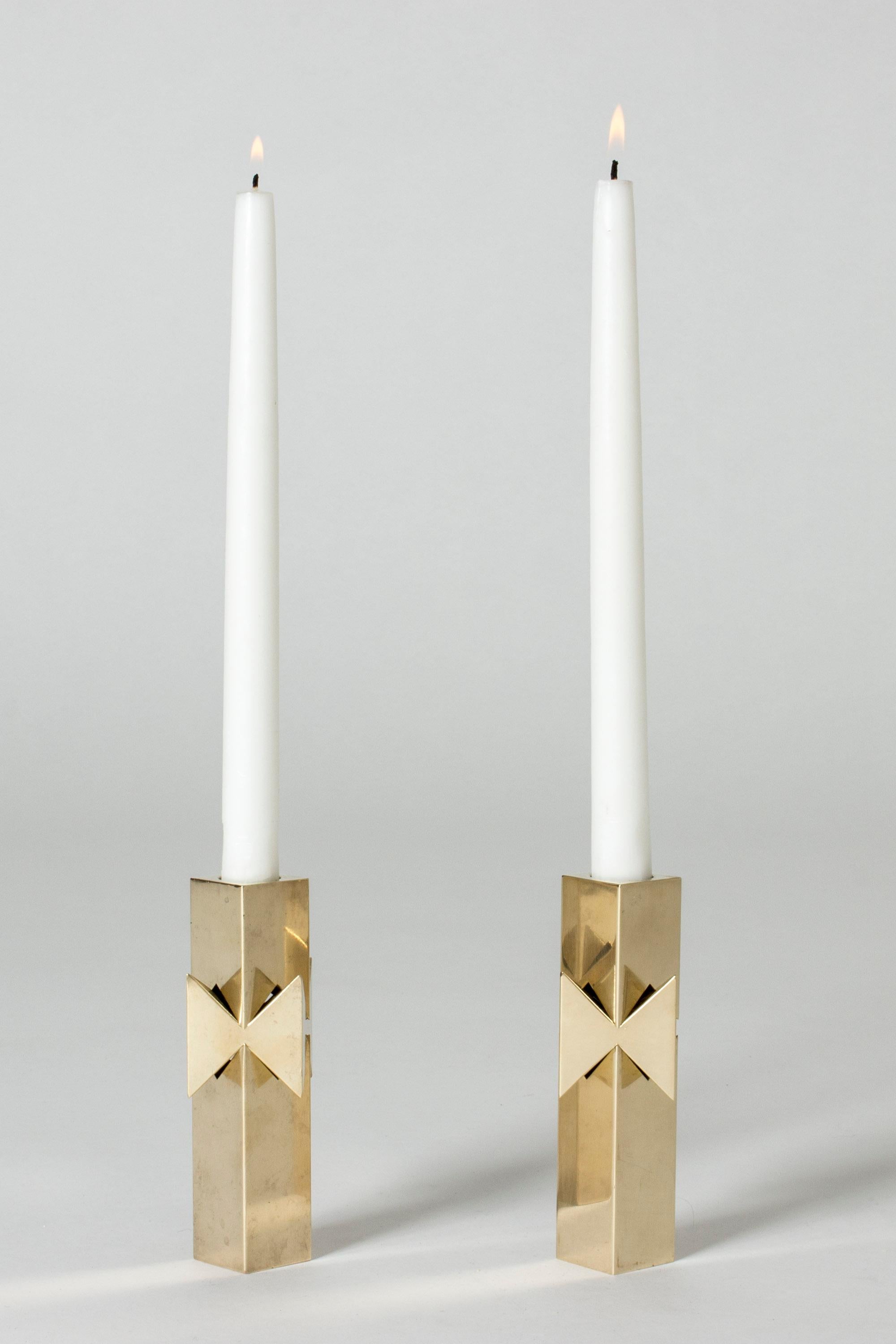 Pair of amazing brass candlesticks, model called “Rosett” (“Bow”). Heavy quality and sober design that looks great and sculptural with or without candles.