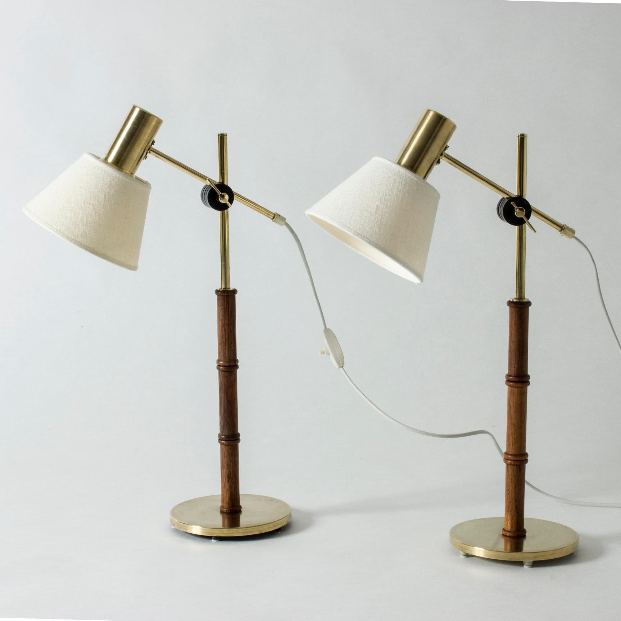 Pair of really cool table lamps from Falkenbergs Belysning, made from brass with rosewood handles. Wood carved into a bamboo-stem form. Adjustable height and angle of the shades.