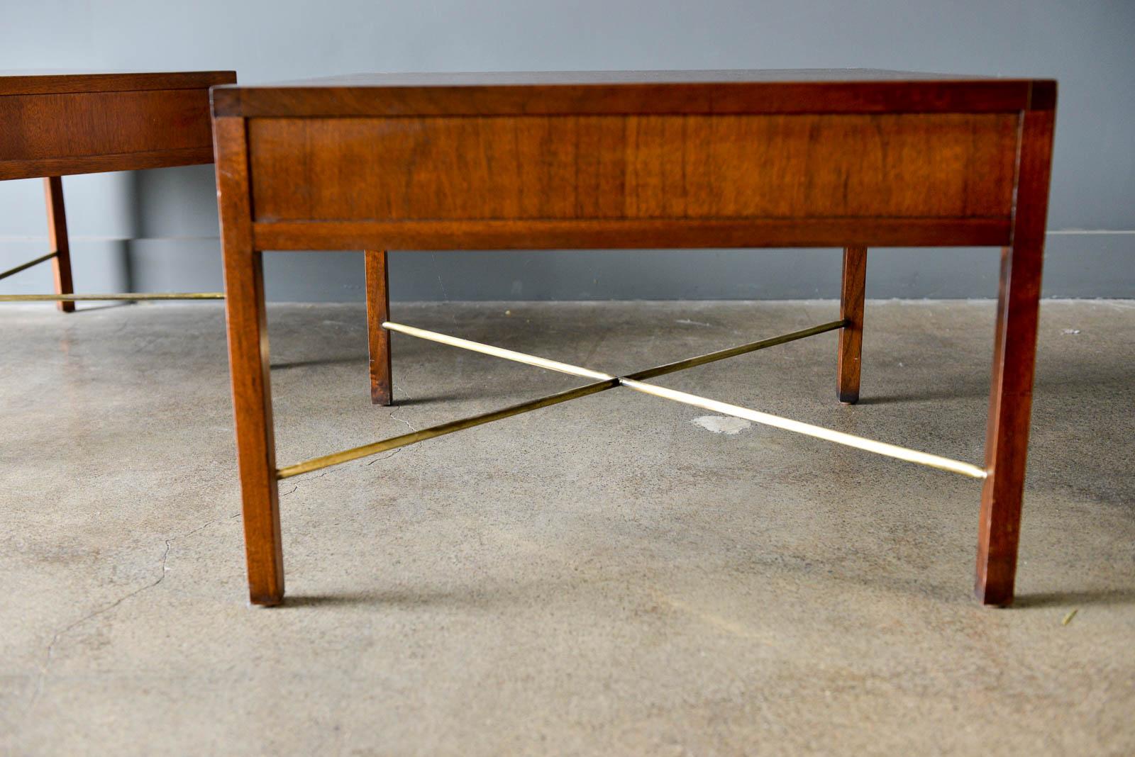 Pair of rosewood and brass X base side or end tables, circa 1965. Beautiful rosewood grain with brass X base stretcher bars in good vintage condition. Finished on all sides, these tables can float in the middle of a room. Unmarked, in the style of
