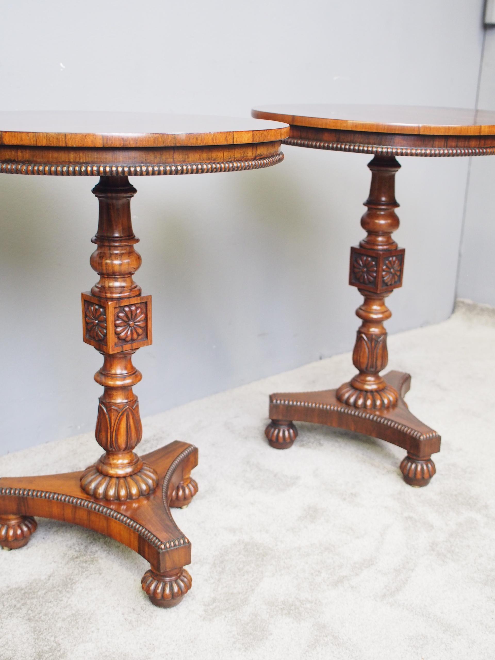 Rare pair of rosewood and Goncalo Alves circular occasional tables, circa 1830. The tops have well figured rosewood veneers, with a simple fore-edge featuring half round beading. This leads on to a pedestal stem with a variety of ring turning and
