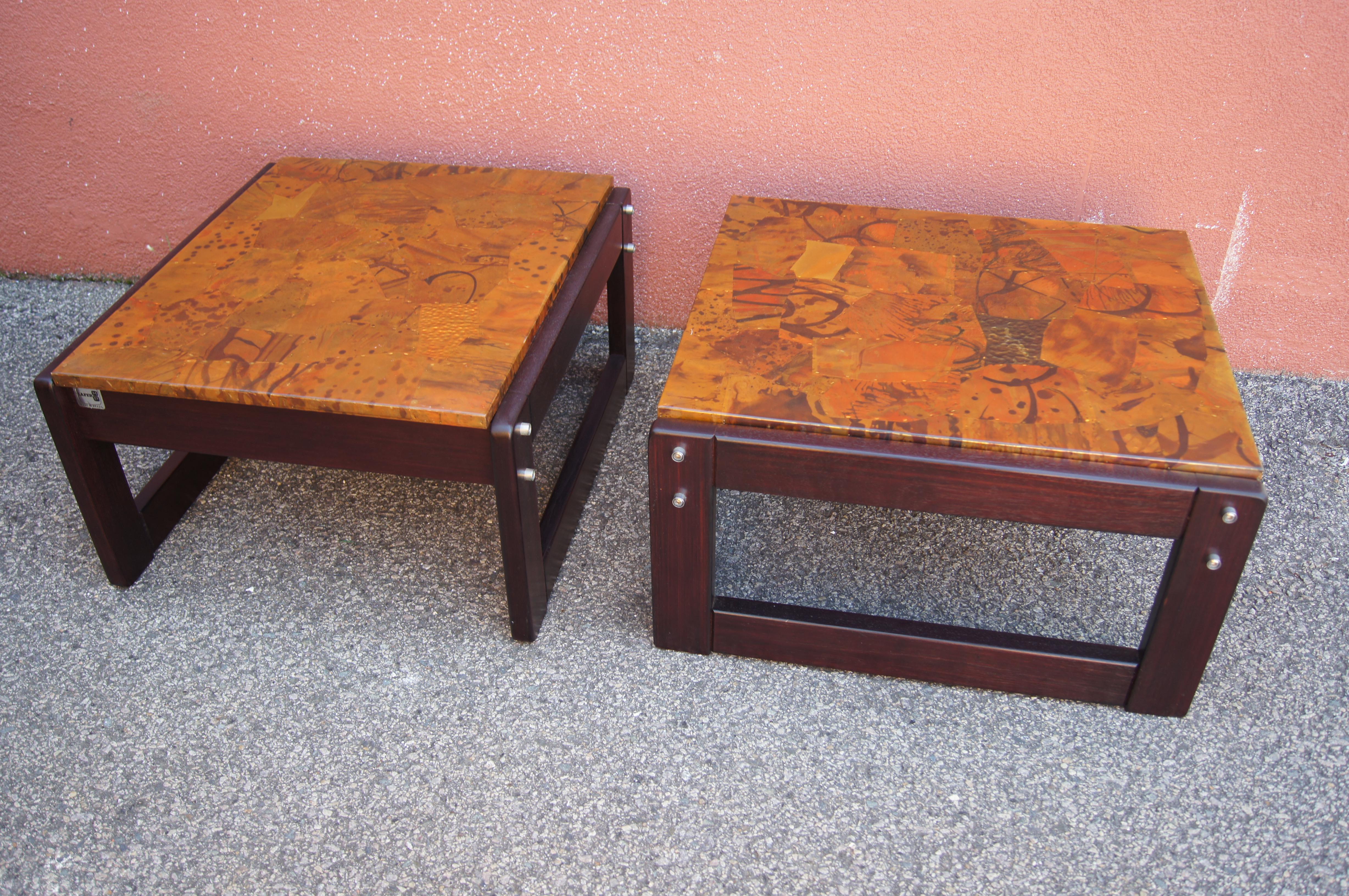 Designed by Brazilian modernist Percival Lafer, this pair of jacaranda rosewood side tables features bold rectangular frames with exposed hardware and tops of beautifully patinated patchwork copper. 

Lafer label on frame.

We have a corresponding