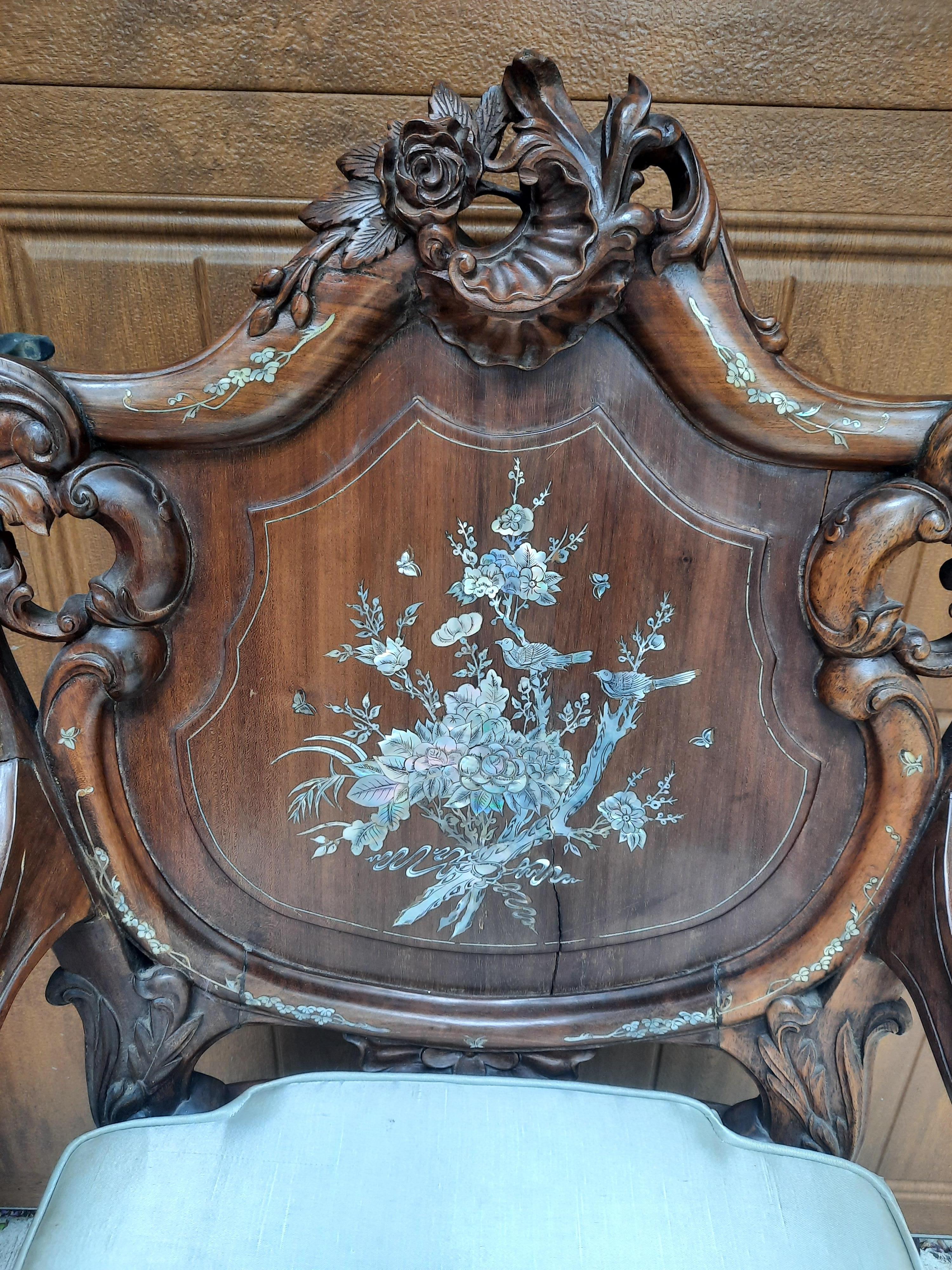 Beautifully detailed with Mother of Pearl these chairs were made by hand in Singapore in the late 20th Century. Made from Rosewood which is a dense, heavy hard wood which is then meticulously carved with an array of natural designs. Carved flowers