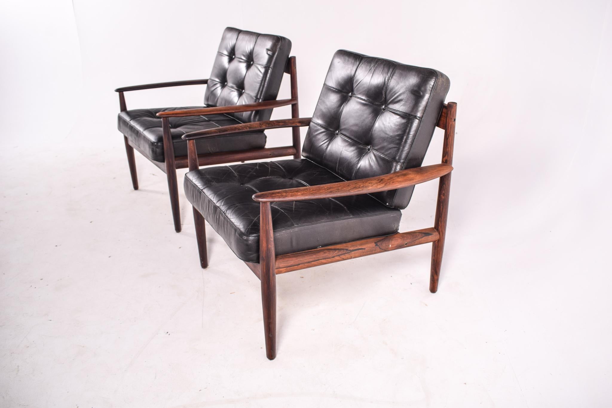 Very comfortable pair of astonishing rosewood lounge chairs by designer Grete Jalk, from the 1960s. One is stamped by Cado (previously known as France & Son) and another one is stamped by France & Son. Grete Juel Jalk was a Danish furniture designer