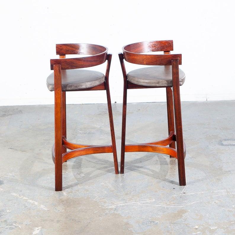 Beautiful solid sculpted figured Brazilian rosewood and bent plywood bar stool and leather set designed by John Mortensen for OD Mobler. Comes with beautiful rosewood grain throughout and is upholstered in the original grey leather. Unique