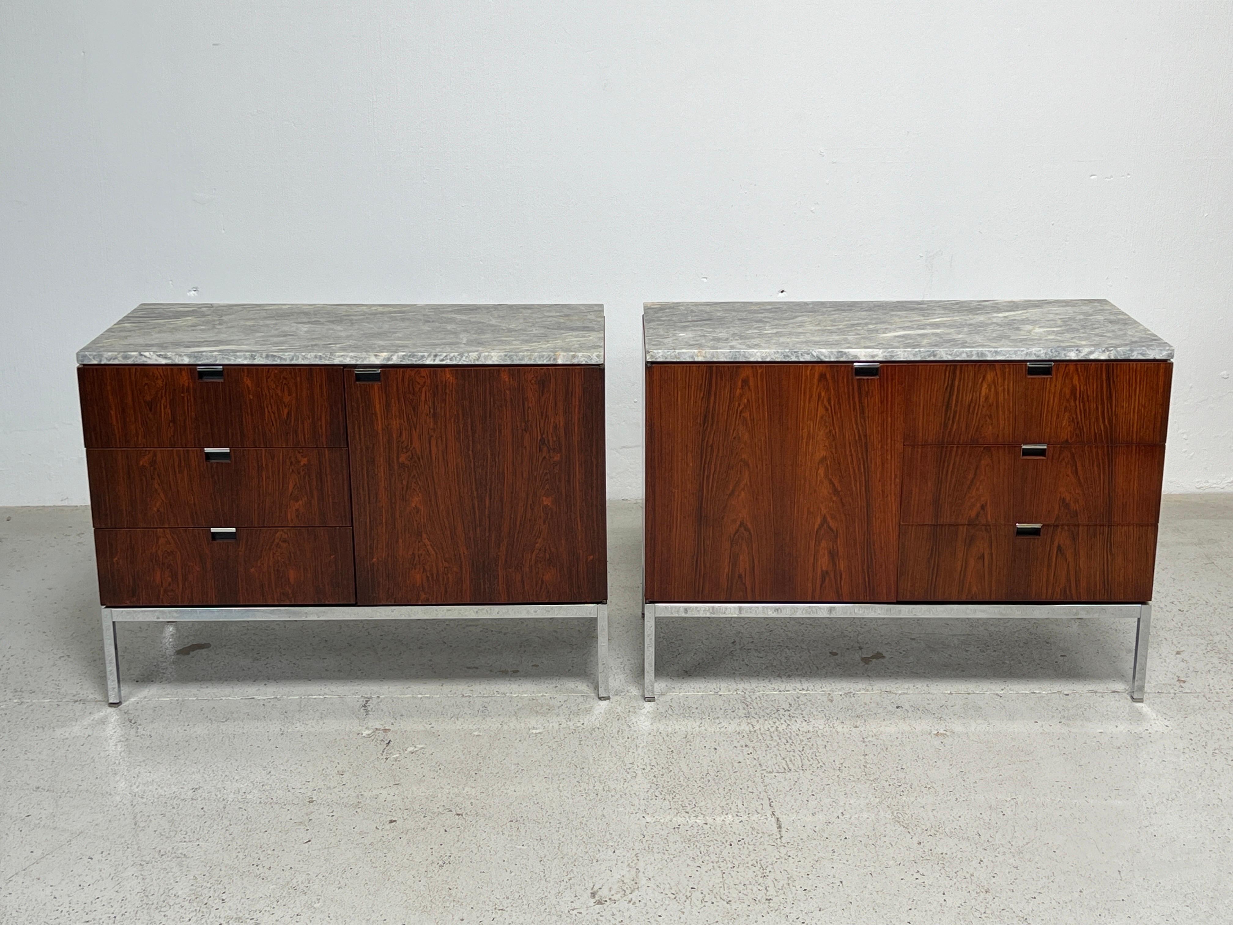  A pair of rosewood credenzas / nightstands with finished backs and marble tops. Designed by Florence Knoll for Knoll. 