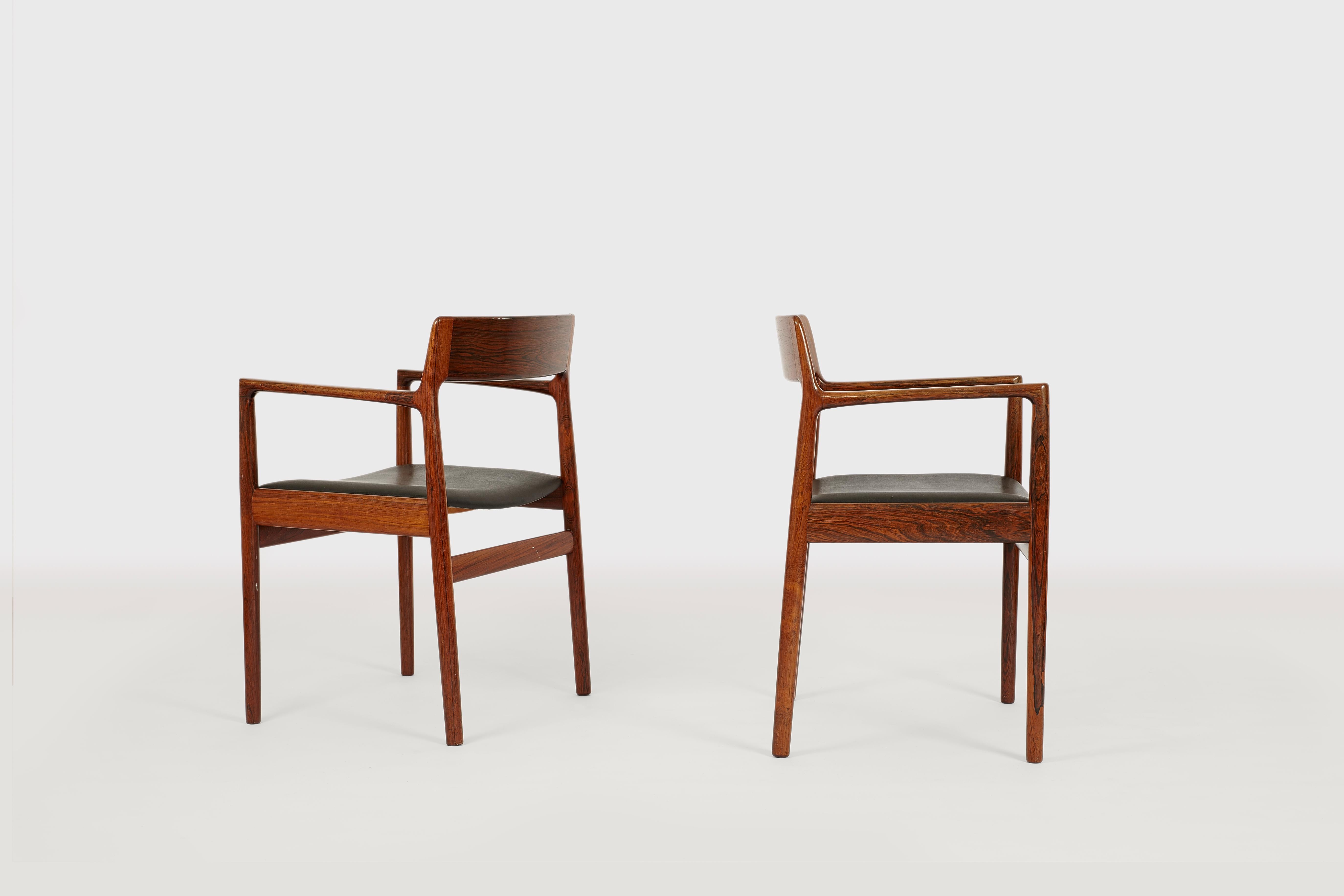 A beautiful pair of massive dining chairs probably Niels O. Møller, Denmark produced by Rodding Denmark Norgard Furniture Factory. Both chairs are in an excellent condition and made of beautiful grained rosewood and black skai. Wonderful design and