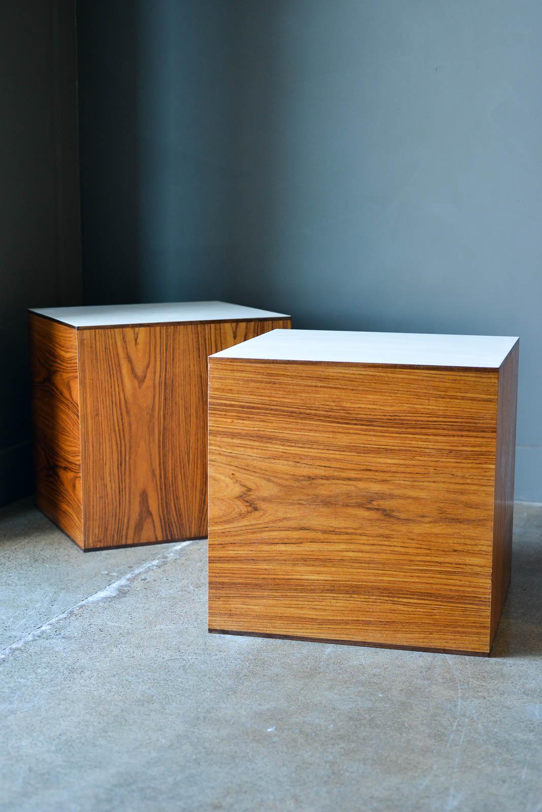 Pair of Rosewood end tables or pedestals by Milo Baughman, 1970. Beautiful rosewood grained tables with original white laminate tops on one side. Tables are in very good original condition with only slight wear. White laminate is also very good with