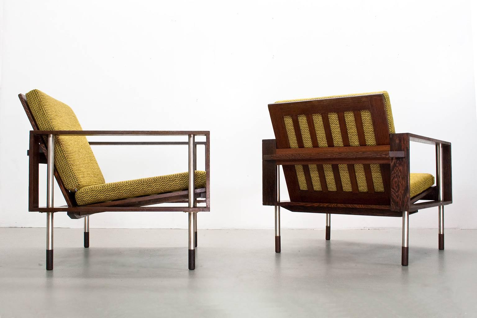 Pair of Mid-Century Modern lounge chairs, in manner of Dutch, 1950s furniture manufacturer Fristho. The set is in very good condition, new upholstered by the previous owner in a good quality black and yellow fabric. wengé frame, with nice details at