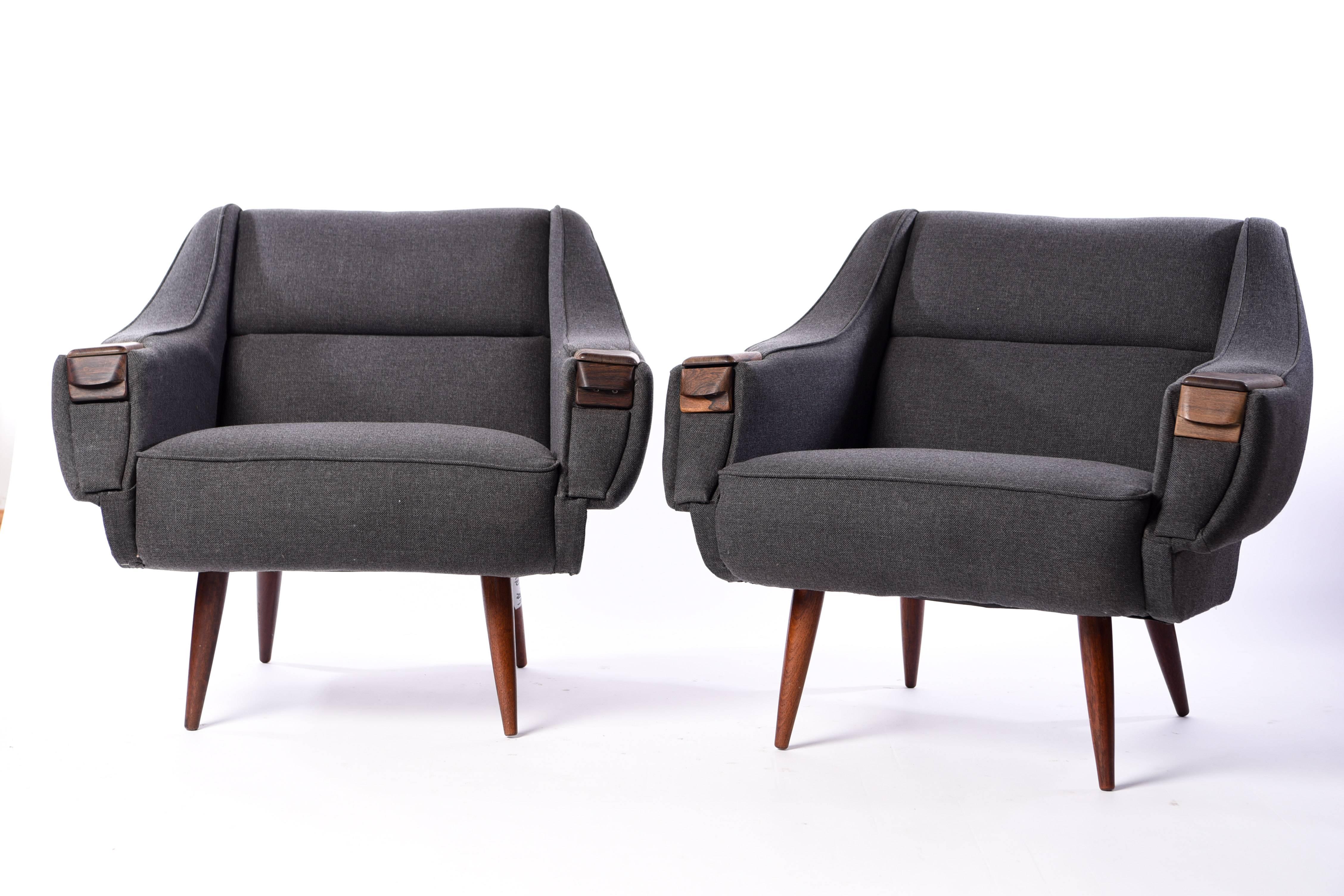 This pair of lounge chairs were designed by H.W. Klein and feature rosewood arm pads and legs. They have been newly upholstered in a stylish gray color.