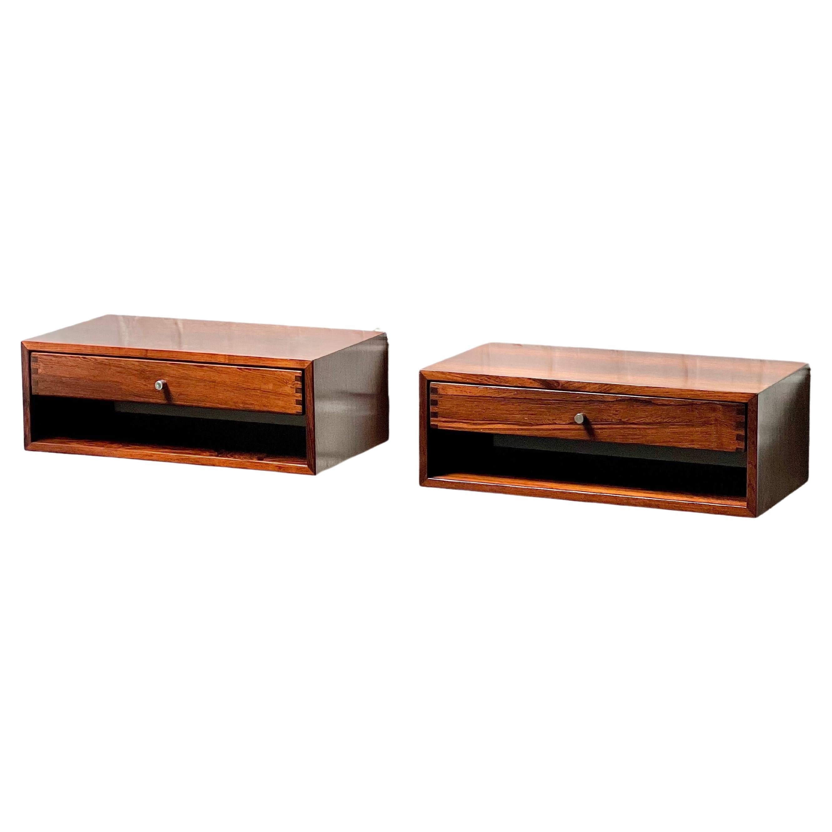 This is a pair of floating consoles/ nightstands. The model is extremely rare and rarely offered in rosewood. Made of the finest veneer. The drawer is made of massive rosewood and the joinery on the sides offer a nice pattern. Perfect as nightstands