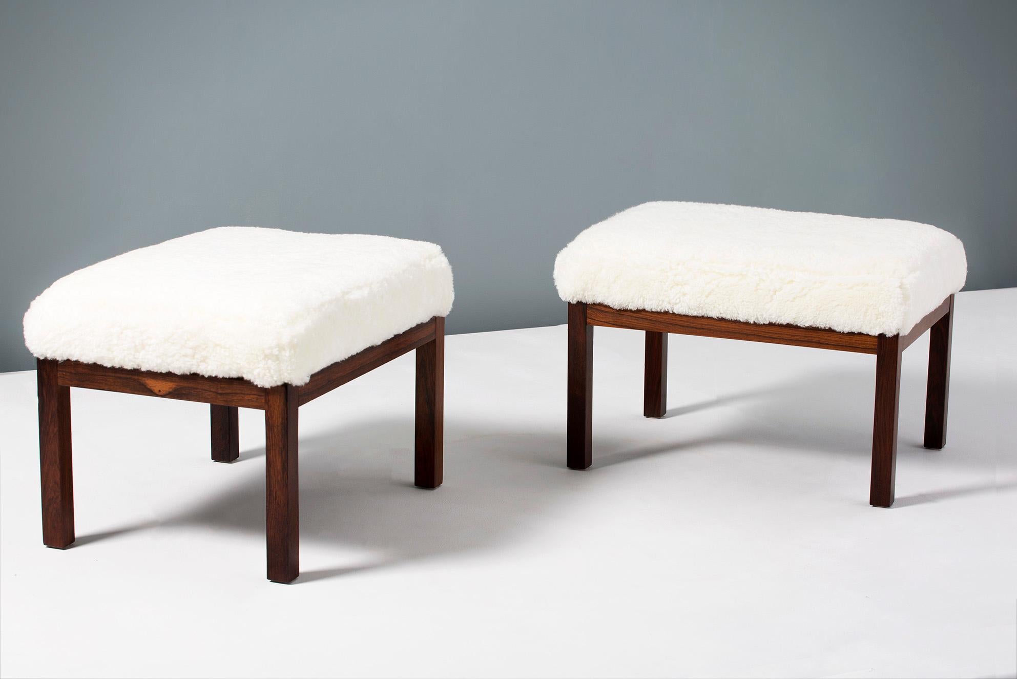 Pair of rectangular ottomans, produced in Denmark in the 1950s. 

Solid rosewood frames with rectangular seats covered in new off-white shearling sheepskin upholstery from New Zealand. 


 