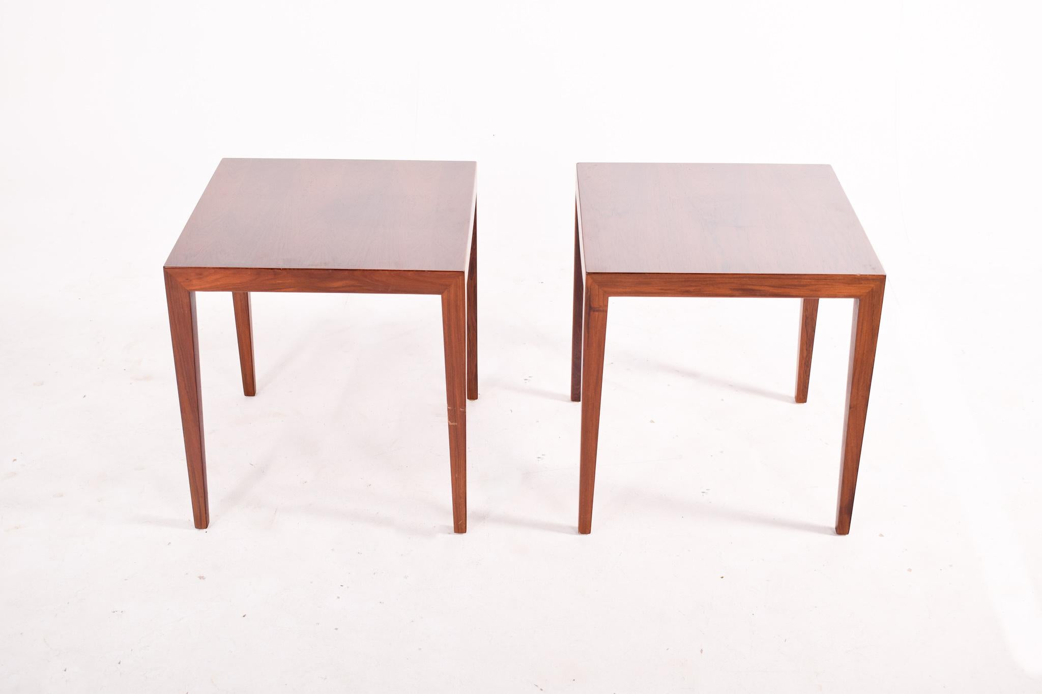 A pair of rosewood side tables with beautiful handcrafted details designed by Erik Severin Hansen and produced in Denmark by Haslev in the 1960’s. Pure and elegant shaped tables with have lovely wood grain. This tables can work in the bedroom as