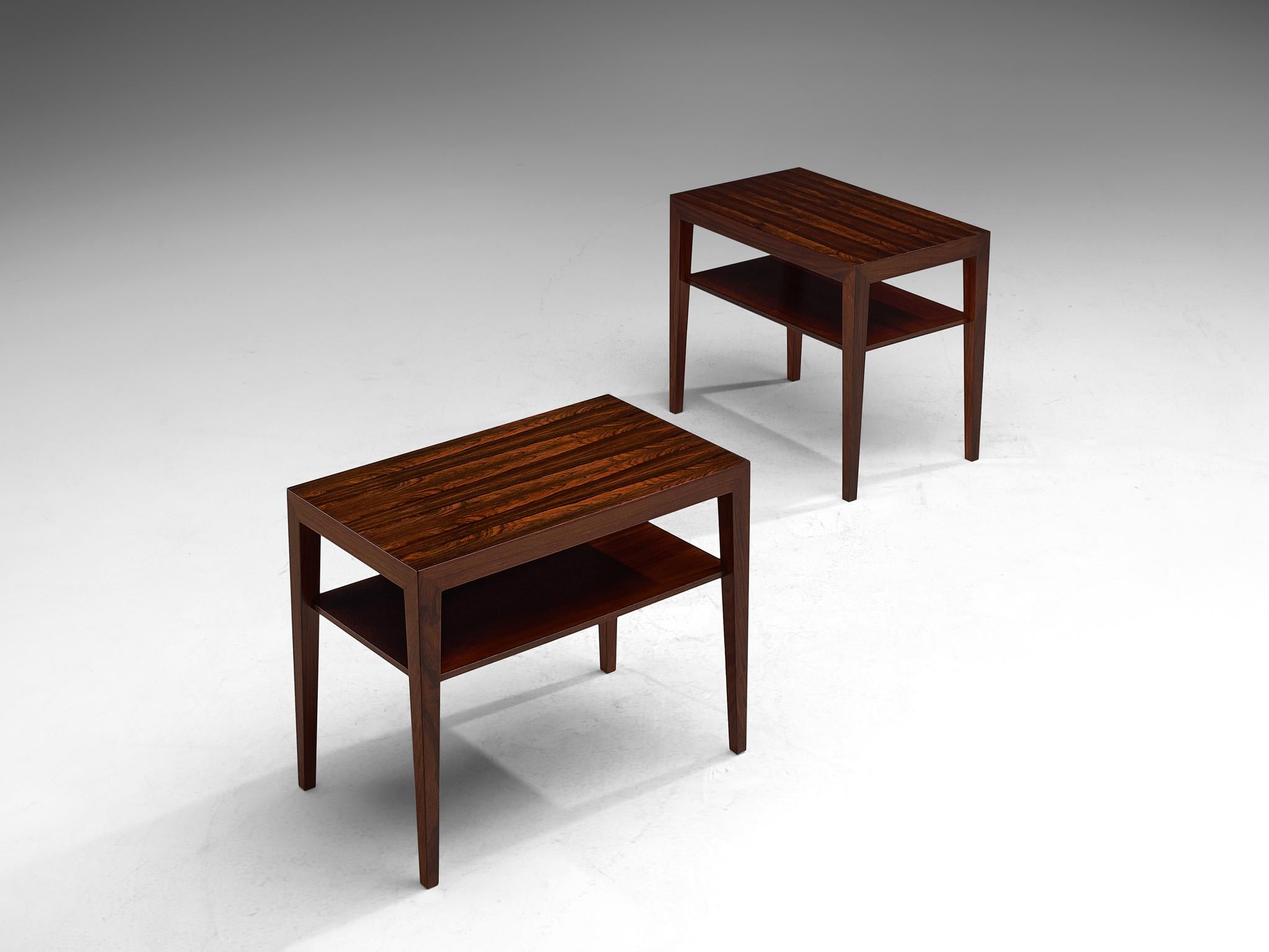 Severin Hansen Jr. for Haslev Møbelsnedkeri, side tables, rosewood, Denmark, 1950s-1960s.

A pair of rosewood side tables with underlaying shelf. The tables have a clean, modest yet elegant design and feature rectangular tops with tapered legs.