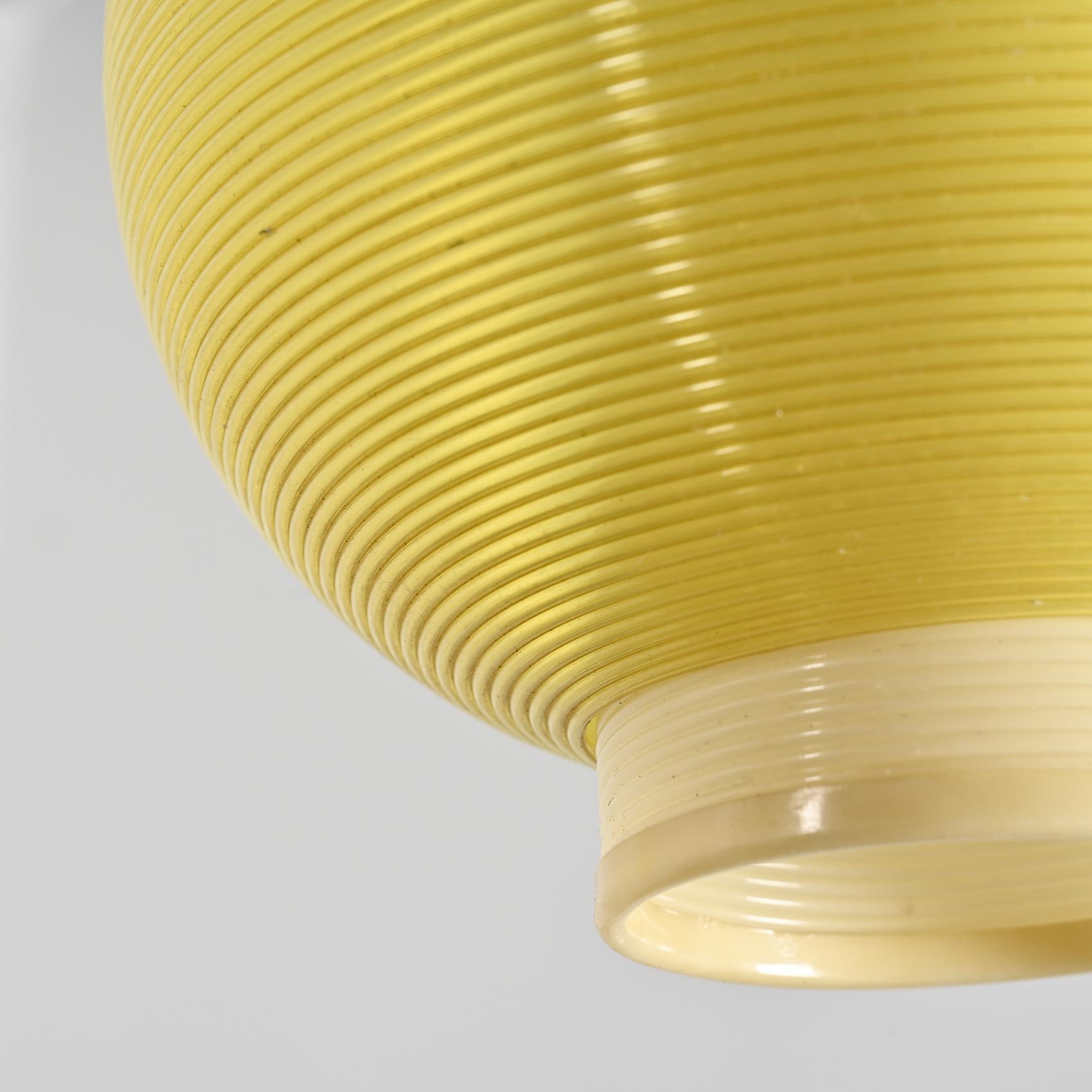 Pair of Rotaflex pendant lights, featuring a main yellow ball-shaped piece, adorned with cream cylinders on each side, and completed with its canopy, dating from the 1960s.

The material used in crafting this pendant light is Rotaflex, an innovative