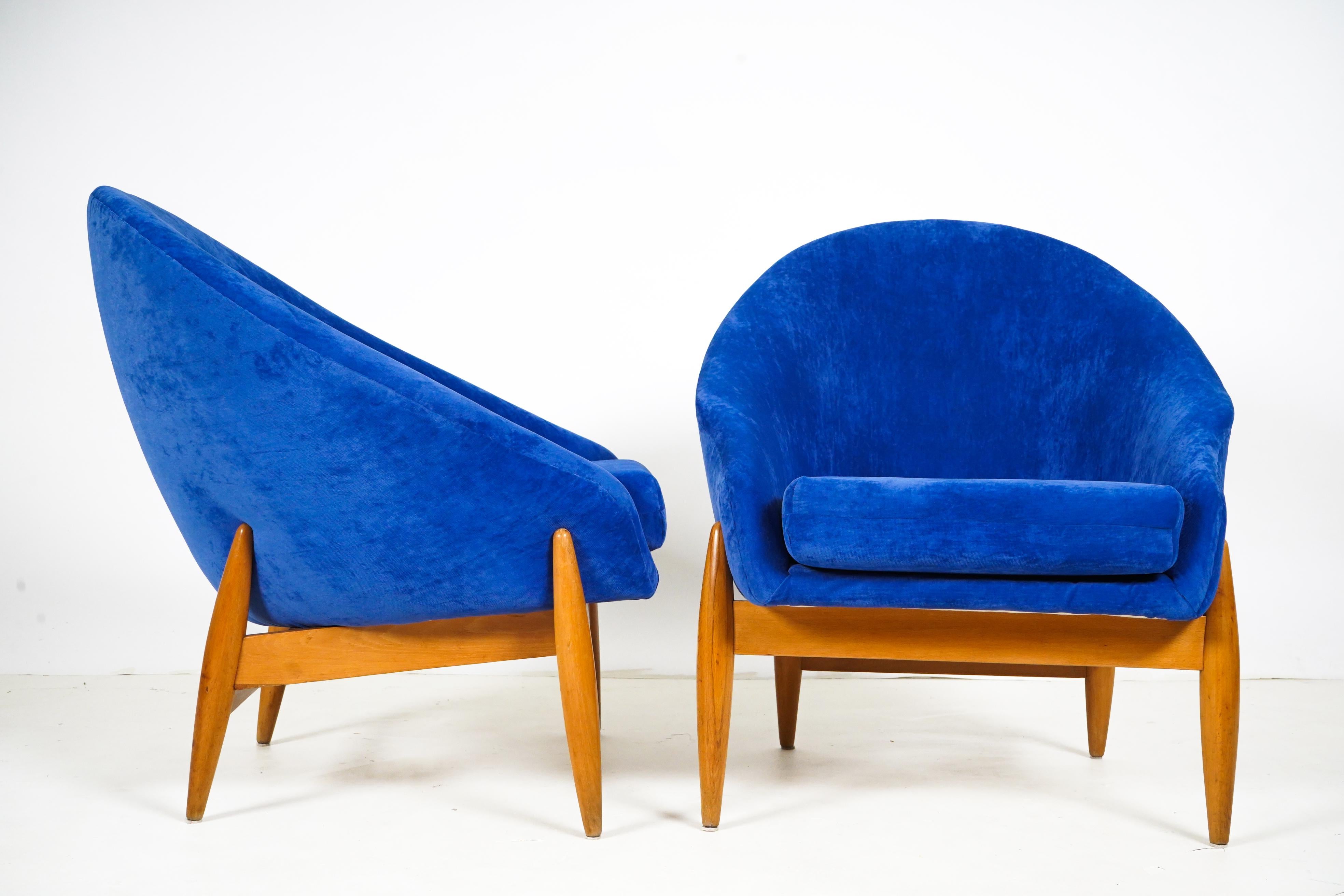 These compact and curvaceous lounge chairs were made in Budapest, Hungary in the 1960's. They are examples of Mid-Century Socialist furniture; the modern furniture made after World War 2 in the countries of the 