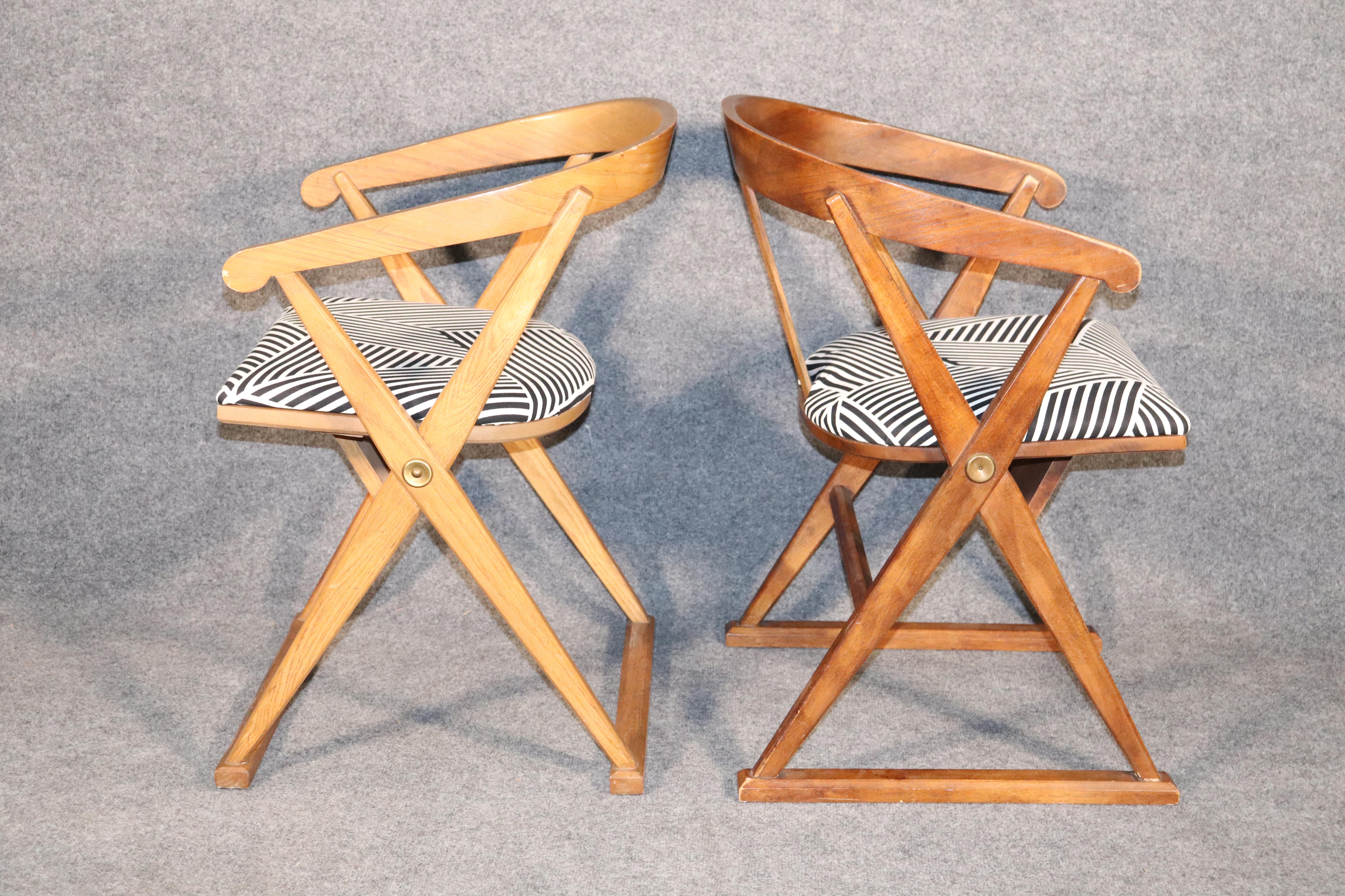 Unique arm chairs with bentwood back connecting to a criss cross frame.
Please confirm location.