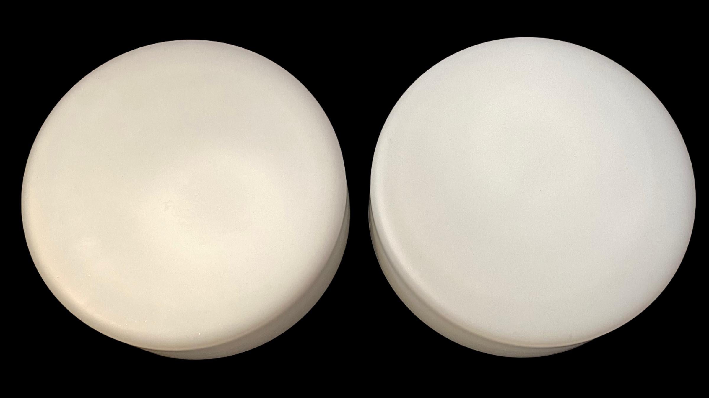 Pair of white milk glass flushmount lights. Made in Germany by RZB Leuchten. Gorgeous textured glass flush mount with metal fixture. Each Fixture requires one European E27 / 110 Volt Edison bulb, up to 60 watts each. Can also be used as a sconce.