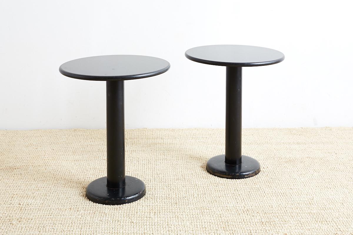Midcentury pair of black granite drink tables featuring a round polished top. Minimalist style with an iron painted base.
