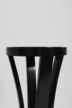 Pair of round black lacquered wooden pedestal tables, 1960s