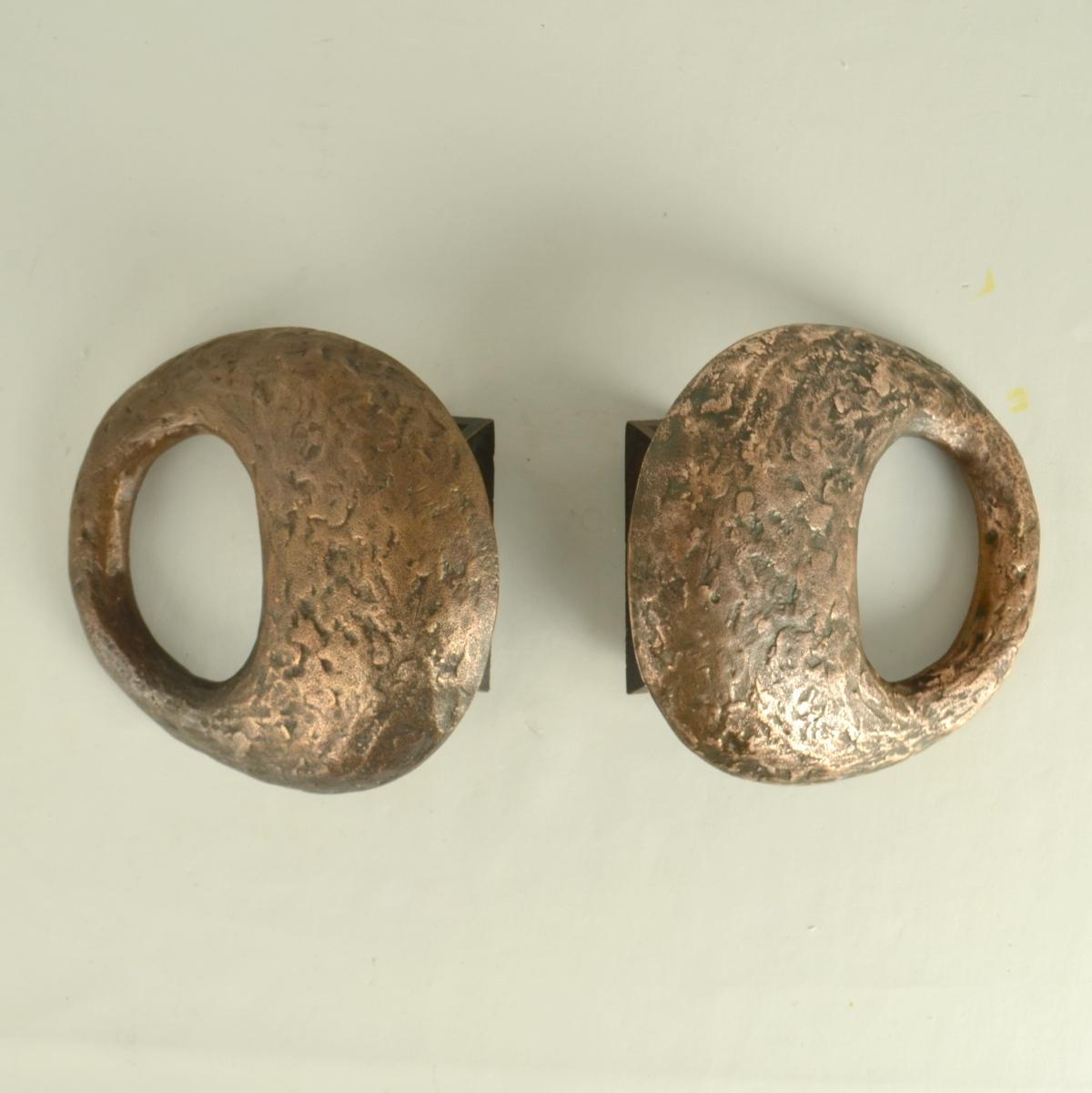 Pair of sculptural round push and pull door handles with an articulated oval hole make a good grip. They are very decorative and give doors an outstanding character and are produced in the 1970's.
The identical handles can be applied on double doors