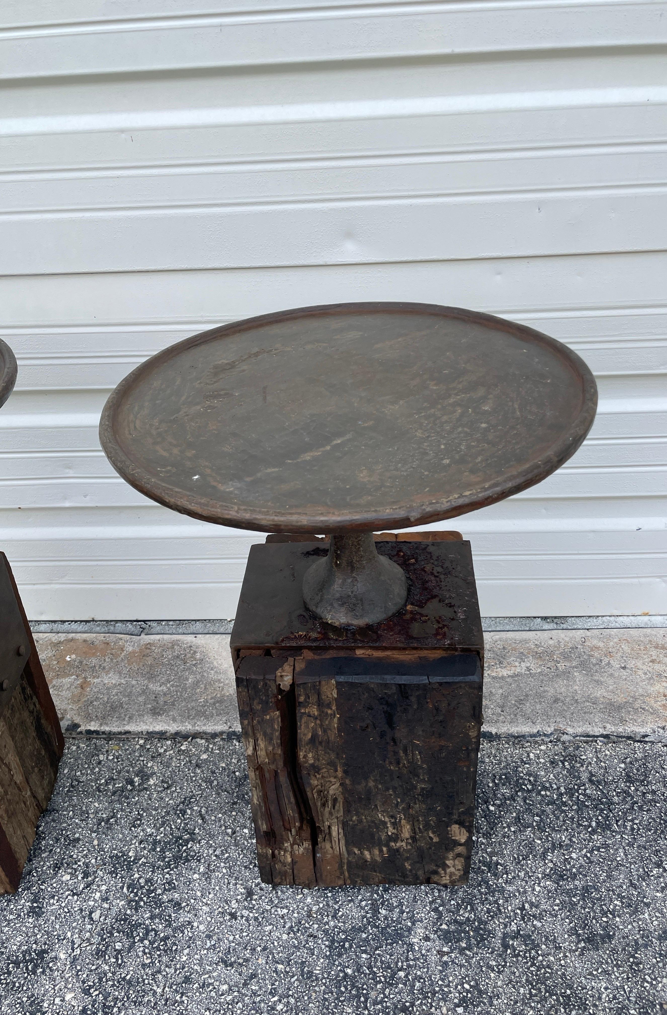 Pair of round cast iron and reclaimed wood rustic side tables. These very unique tables will fit in with most decors, whether inside or out.