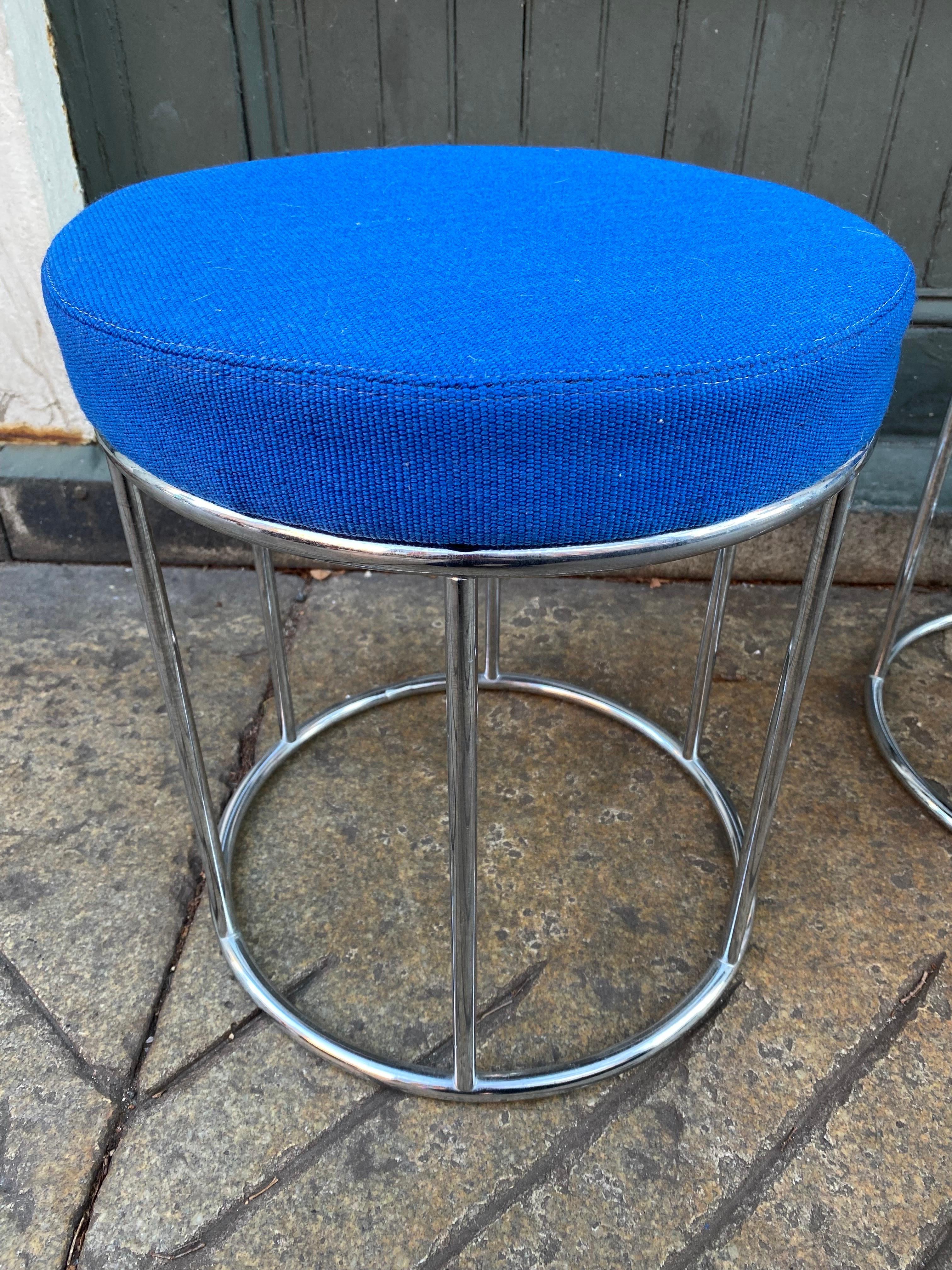 A pair of beautiful low stools with chrome frames and blue upholstered cushions manufactured in Columbus, Indiana by the Cosco Home Products company in the 1960s. Between 1955 and 1980s Columbus, Indiana was an important center of modern