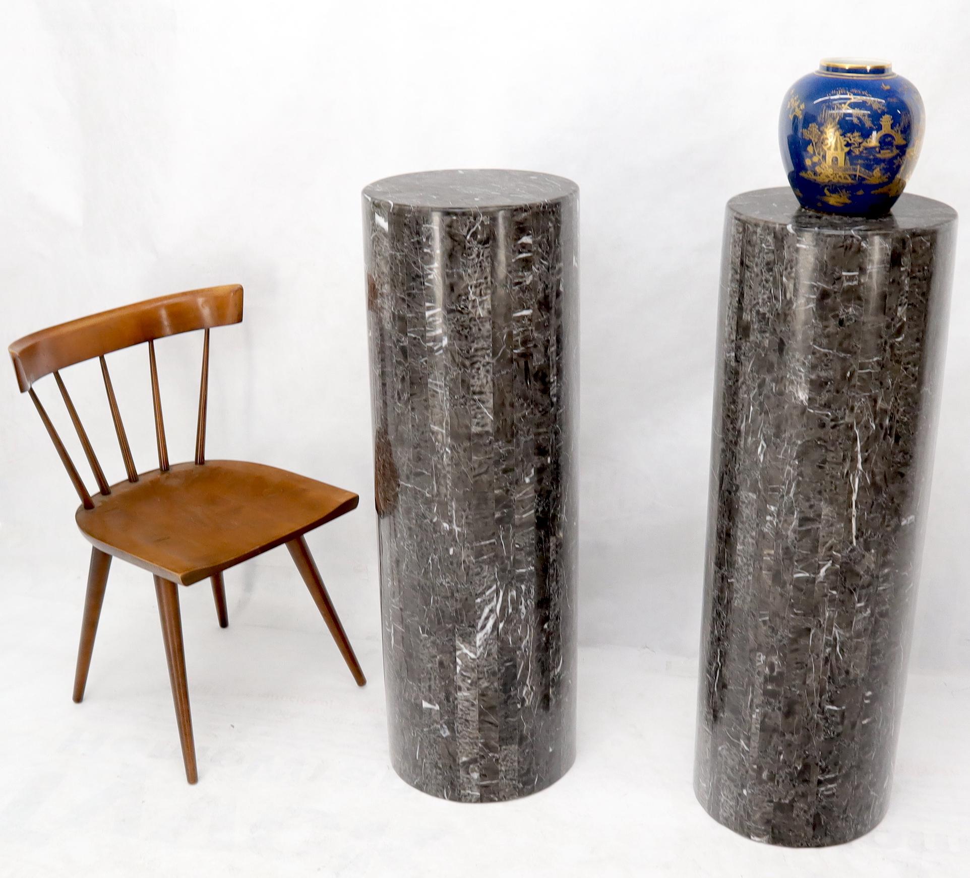 Pair of Mid-Century Modern decorative tessellated black and grey stone marble columns tables.