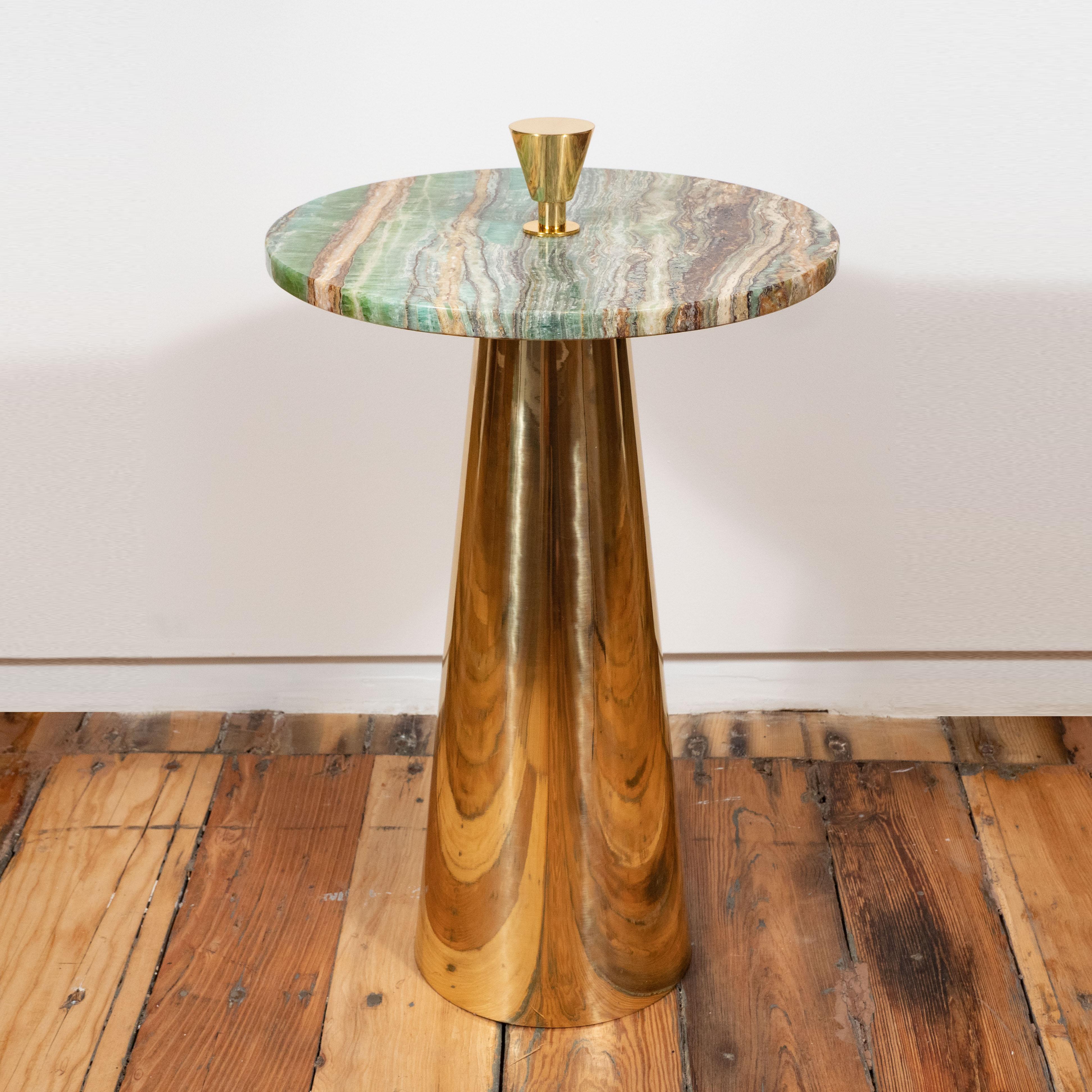 This pair of round emerald green onyx marble top and brass side or martini tables were designed and created in Milan, Italy. Polished emerald green onyx marble which includes ivory and taupe veins sits atop a conical polished brass base. A solid