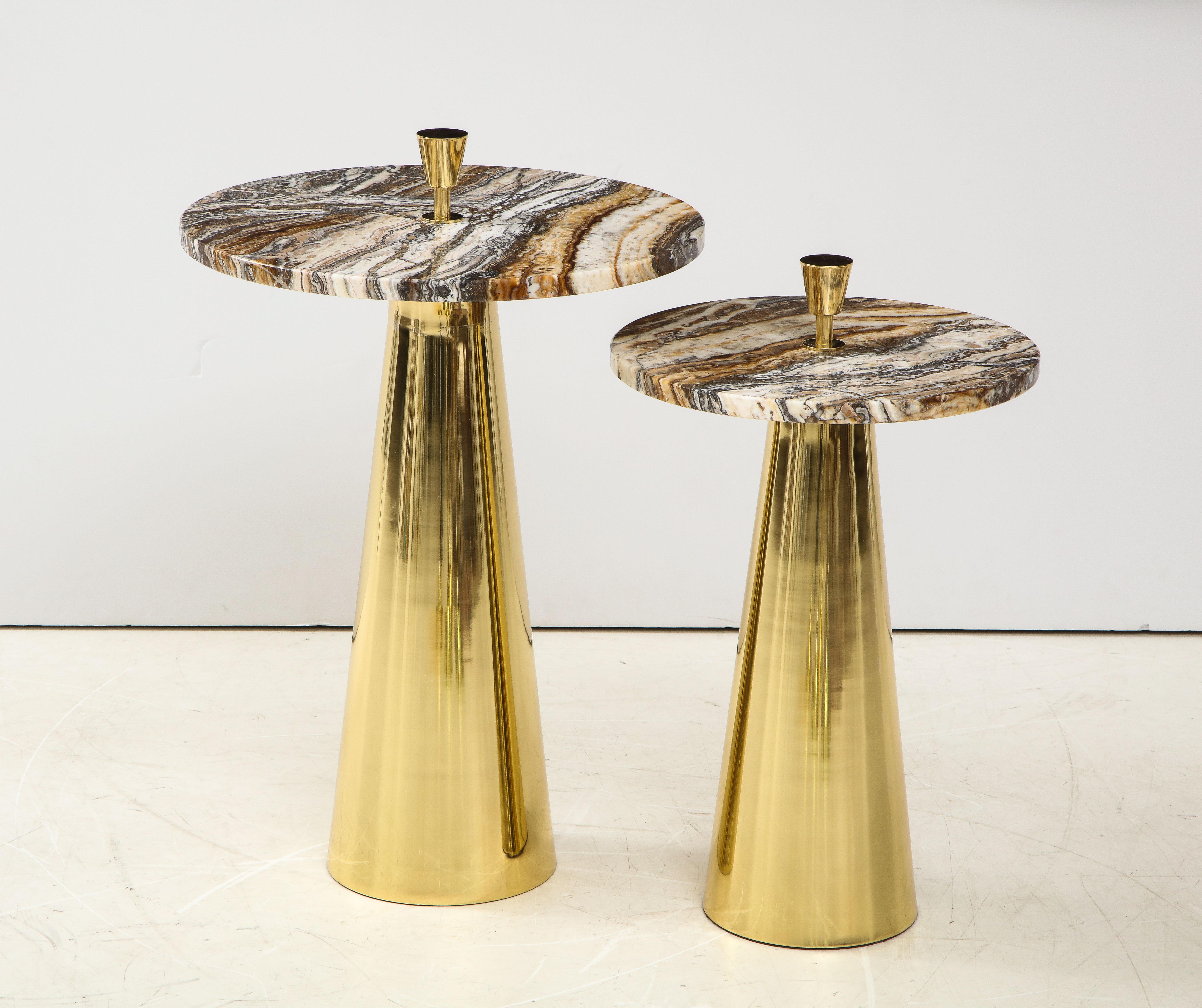 This pair of custom made round fantasy brown onyx marble top and brass side or martini tables were designed and hand crafted in Milan, Italy. Polished and rare fantasy brown onyx marble, which includes bold ivory and taupe veins, sits atop a conical