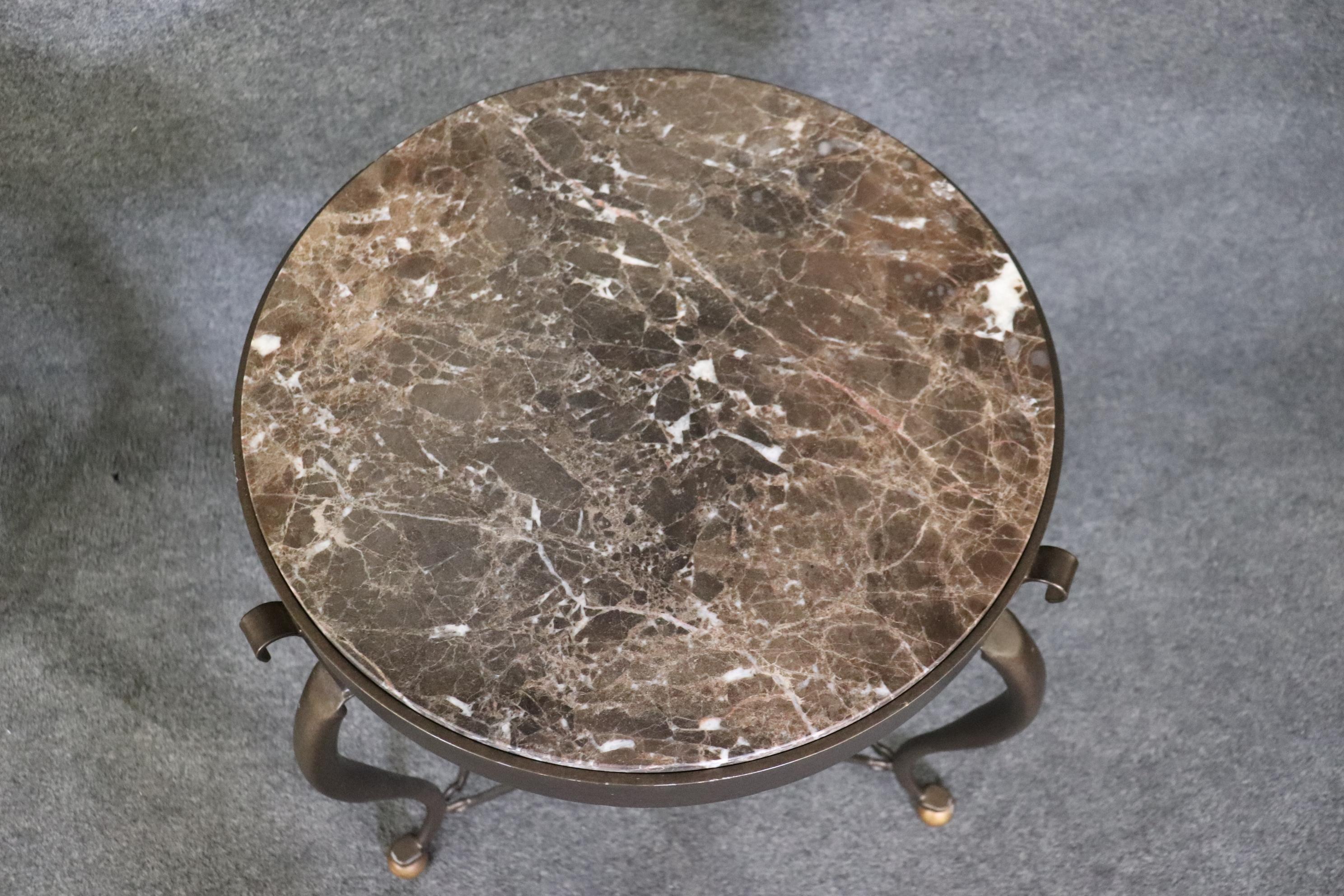 This a beautiful pair of bronze hued steel marble top Directoire style gueridons. They are in the manner of Restoration Hardware. They each are in good used condition and have no major signs of use or abuse. The tables measure 21.5 x 21.5 deep x
