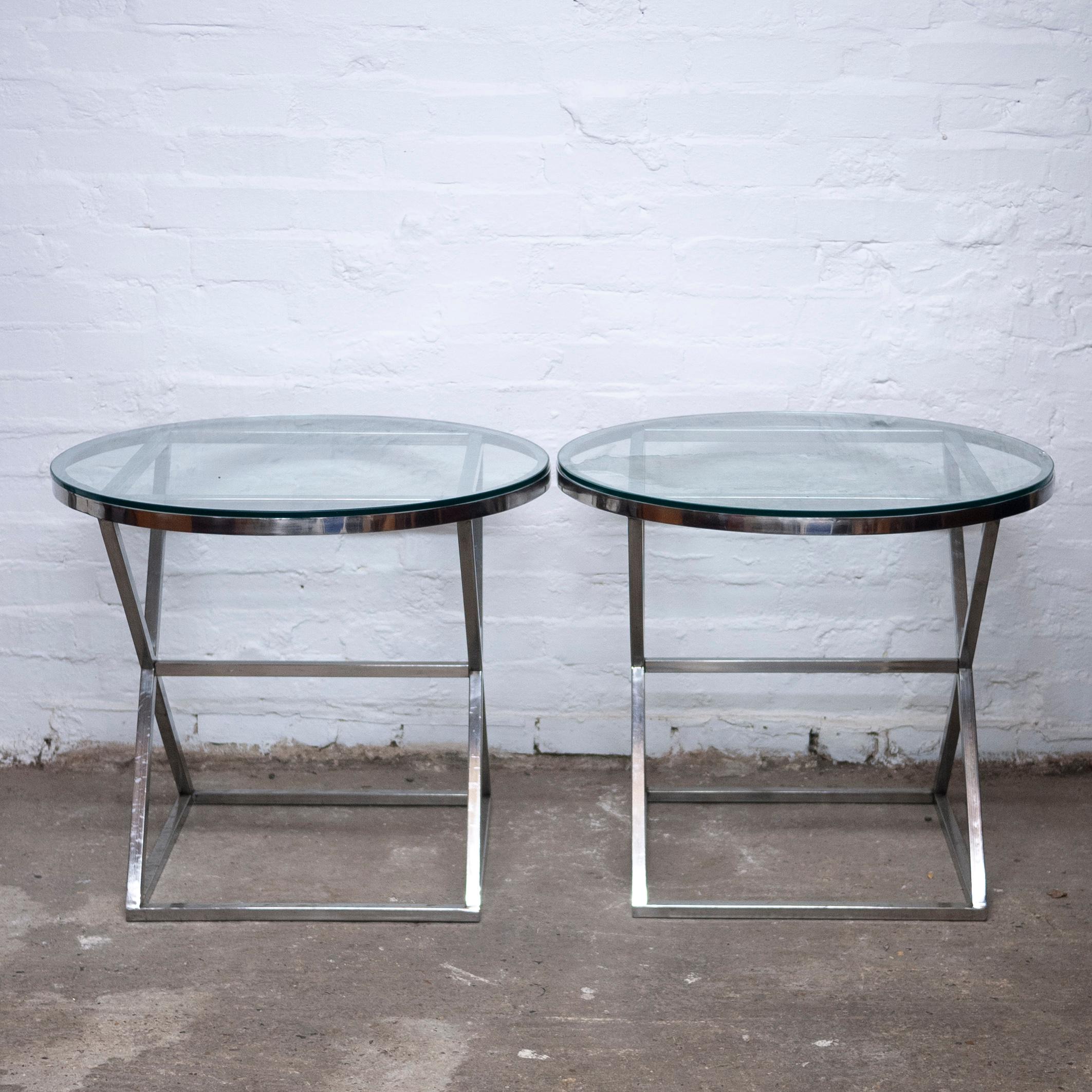 A pair of glass and metal side tables with a crossed base designed.

Designer - Casa Padrino

Design Period - 1990 to 1999

Style - Vintage

Detailed Condition - Good with minimal defects.

Restoration and Damage Details - Light wear consistent with