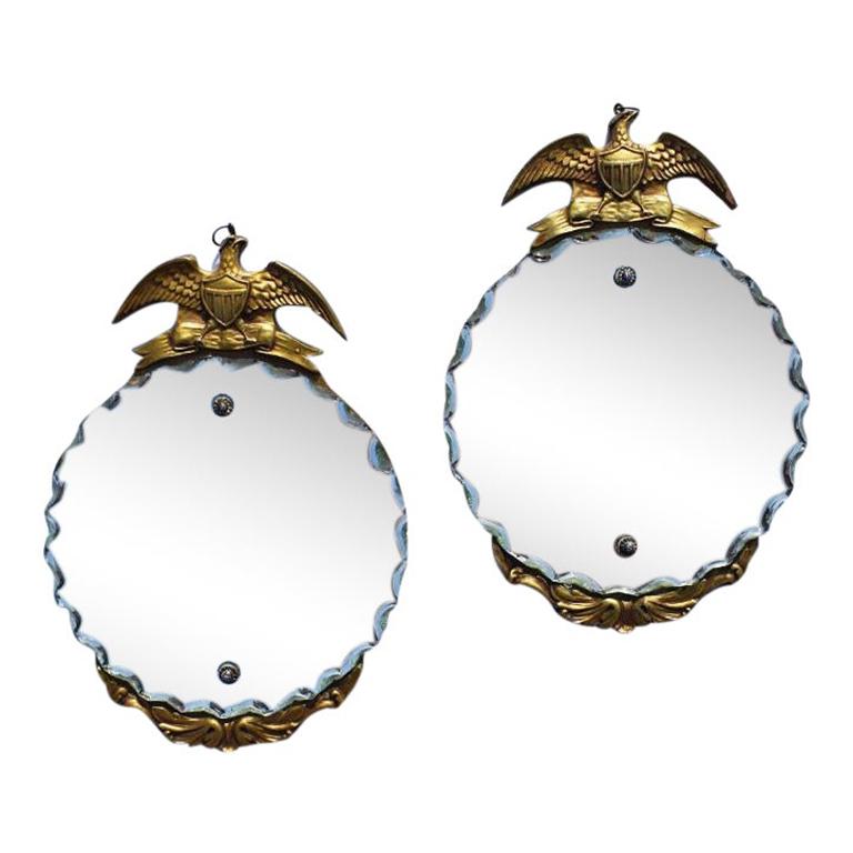 Pair of two round vintage Art Deco Americana traditional federal admiral eagle mirrors. This pair of beautifully crafted antique mirrors would be a stunning addition to any wall. Each mirror features a pie crust, beveled scalloped edge. Mirrors are