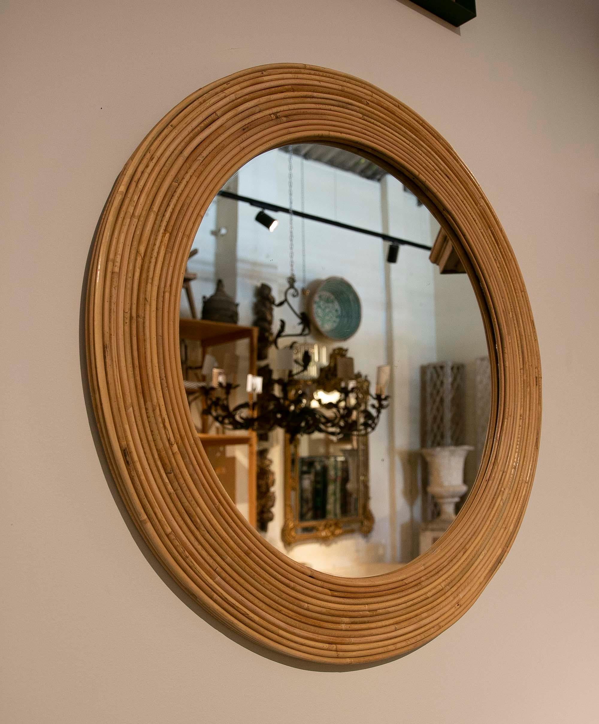 Pair of round handmade wicker wall mirrors.