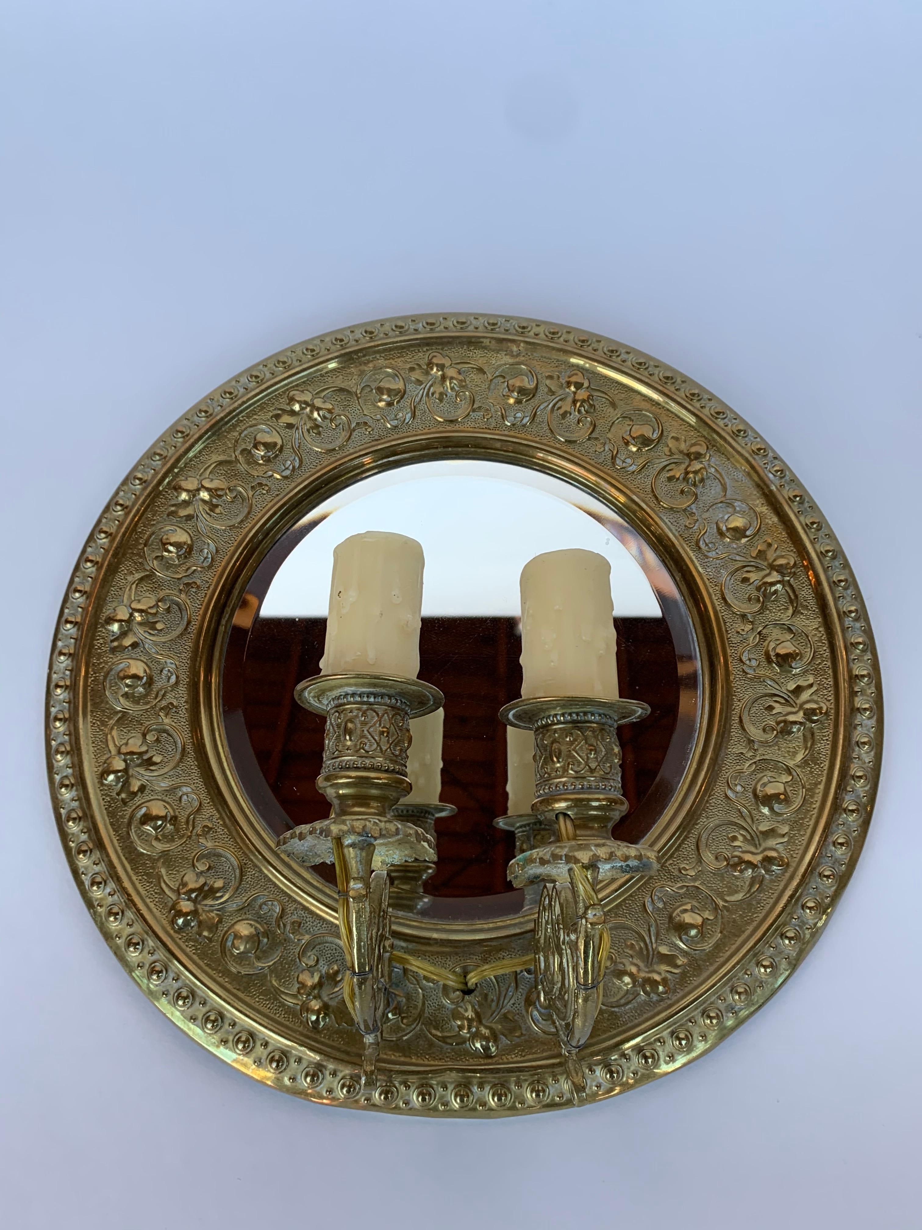 Two Italian brass sconces with beveled mirror in the center.