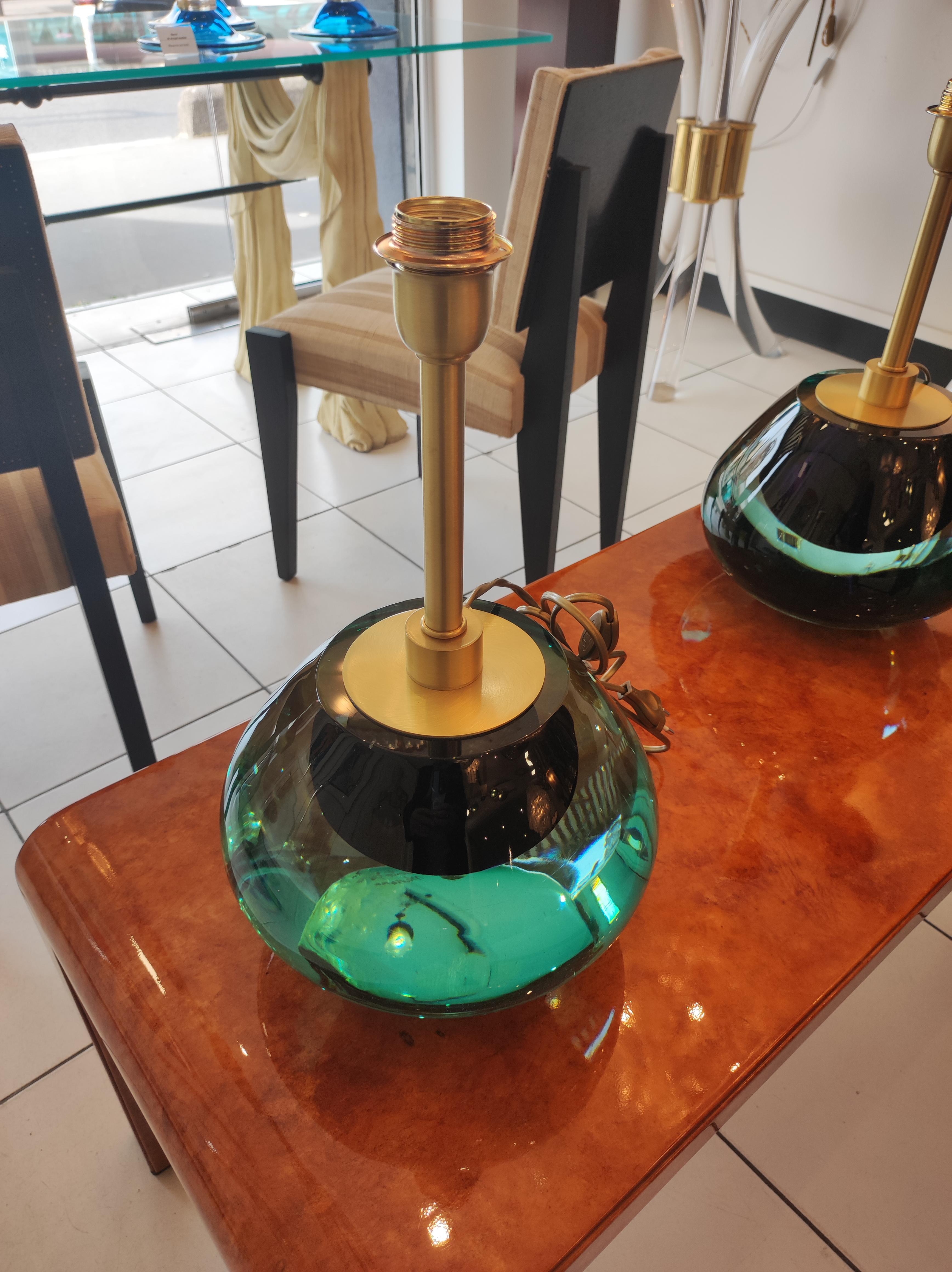 Pair of Italian table lamps in light green/turquoise ( and black in the middle) Murano glass and brass.
E 27 bulbs compatible US E26


