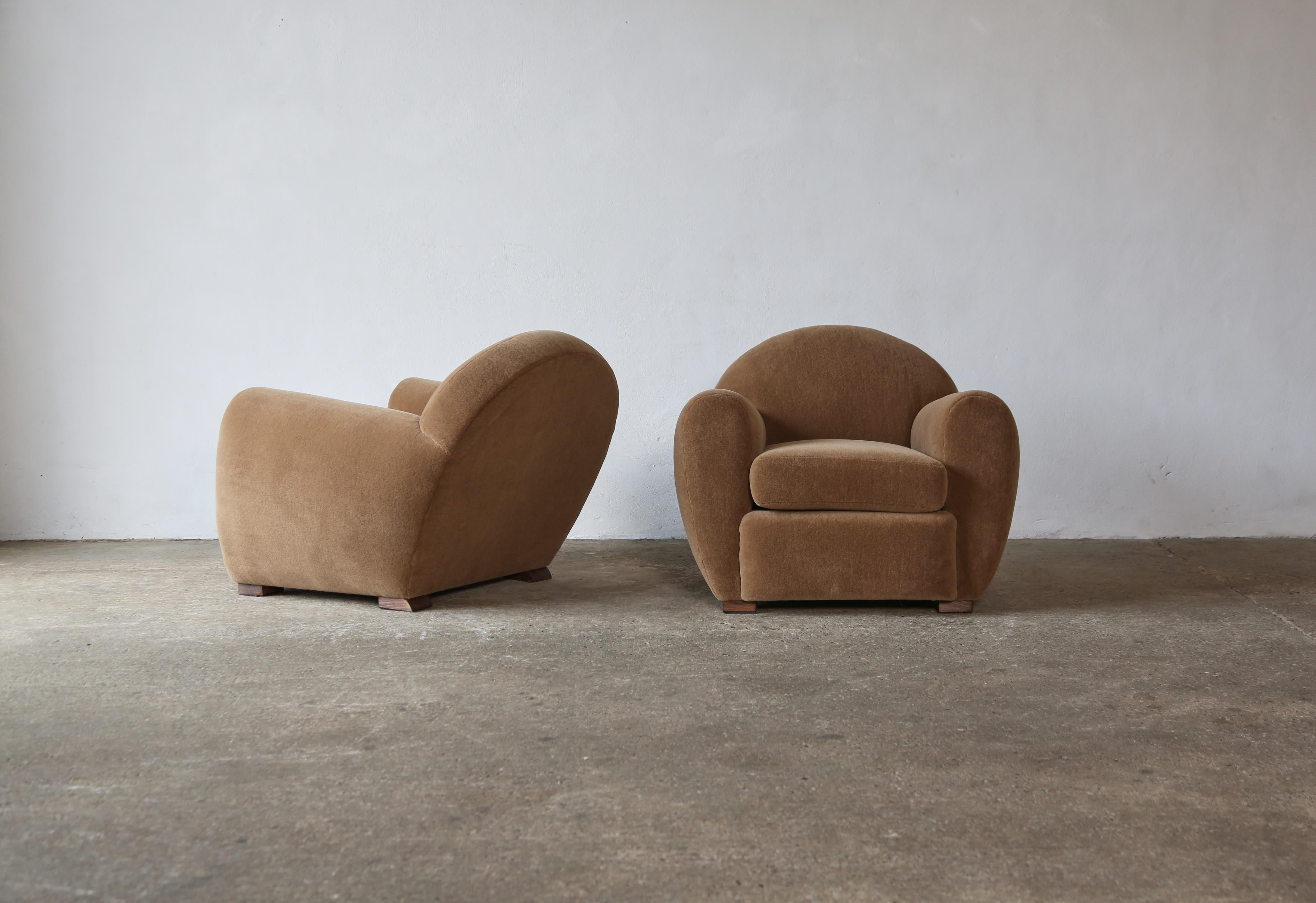 Superb pair of round, leaning modern club chairs, upholstered in COM.  High quality handmade beech frames.   Ottomans available to purchase separately.   Lead times from receipt of fabric and exclude public holiday periods.  Fast shipping